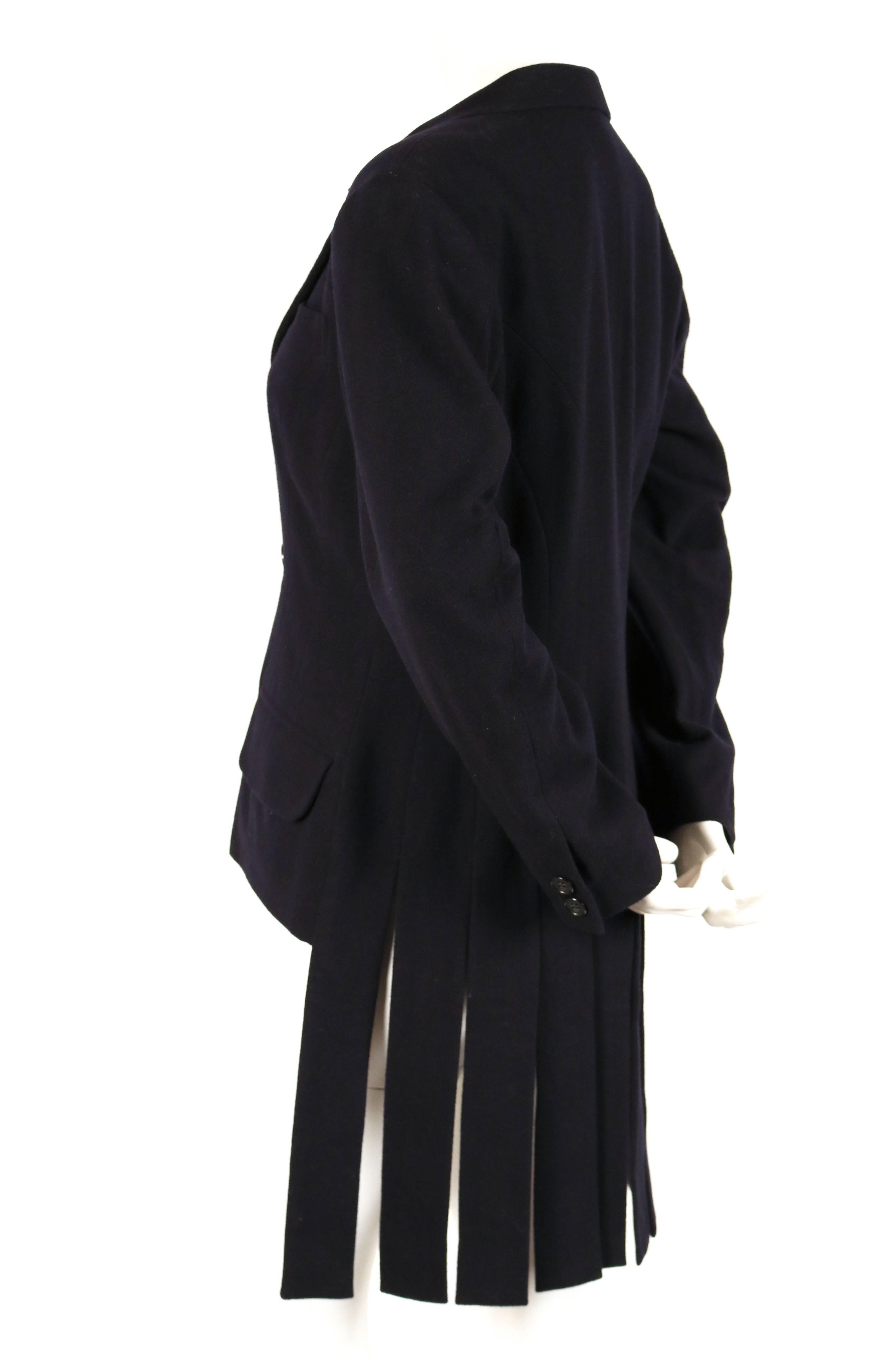 Very rare and unique black wool jacket with carwash hemline designed by Yohji Yamamoto dating to the 1980's. Jacket is labeled a size 'S'. Approximate measurements: shoulder 17
