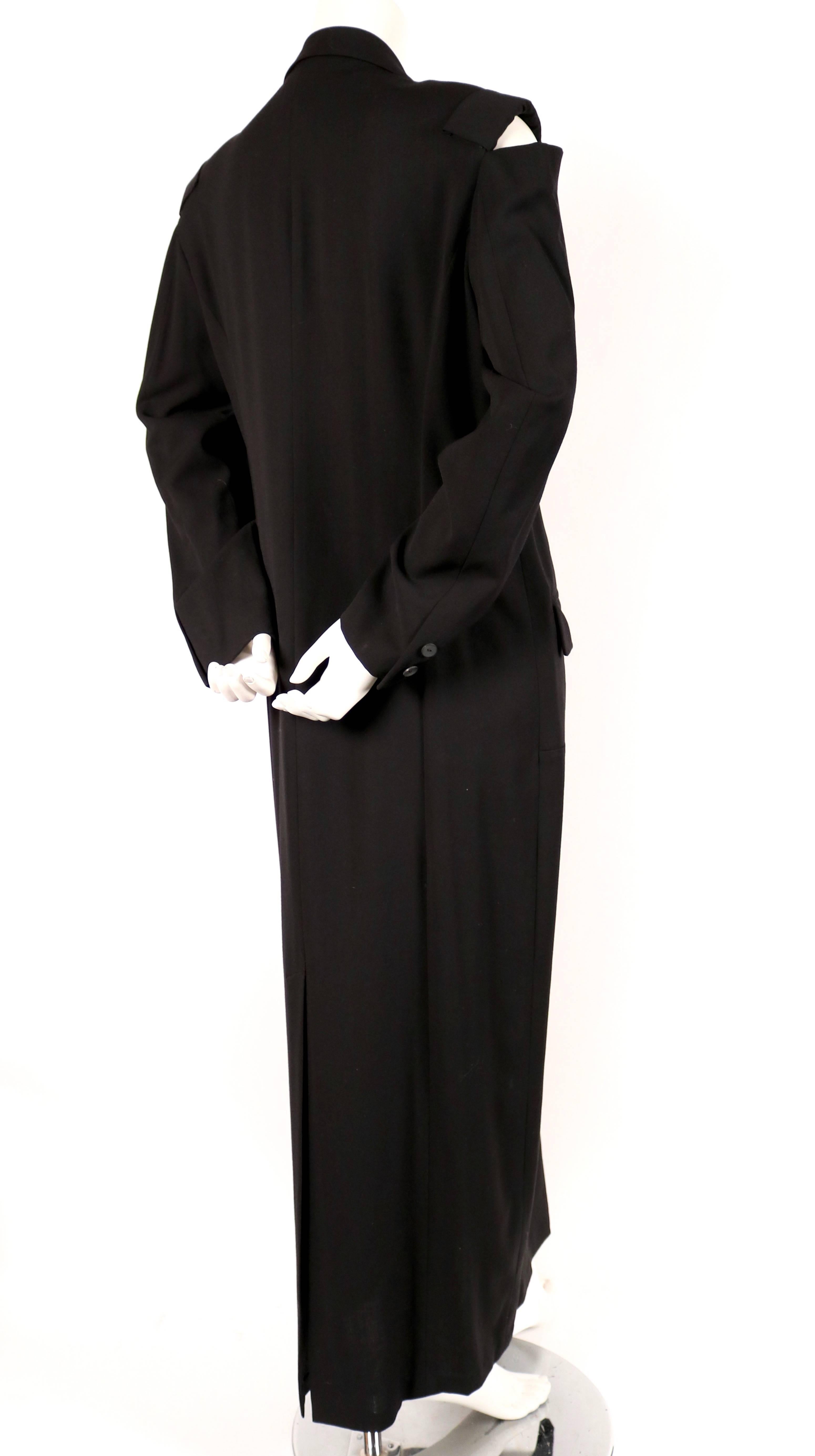 Black long men's style wool dress with cutout shoulders designed by Yohji Yamamoto dating to the 1980's. Labeled a size 'M'. Intended to have a loose oversized fit. Approximate measurements: shoulder 17.75