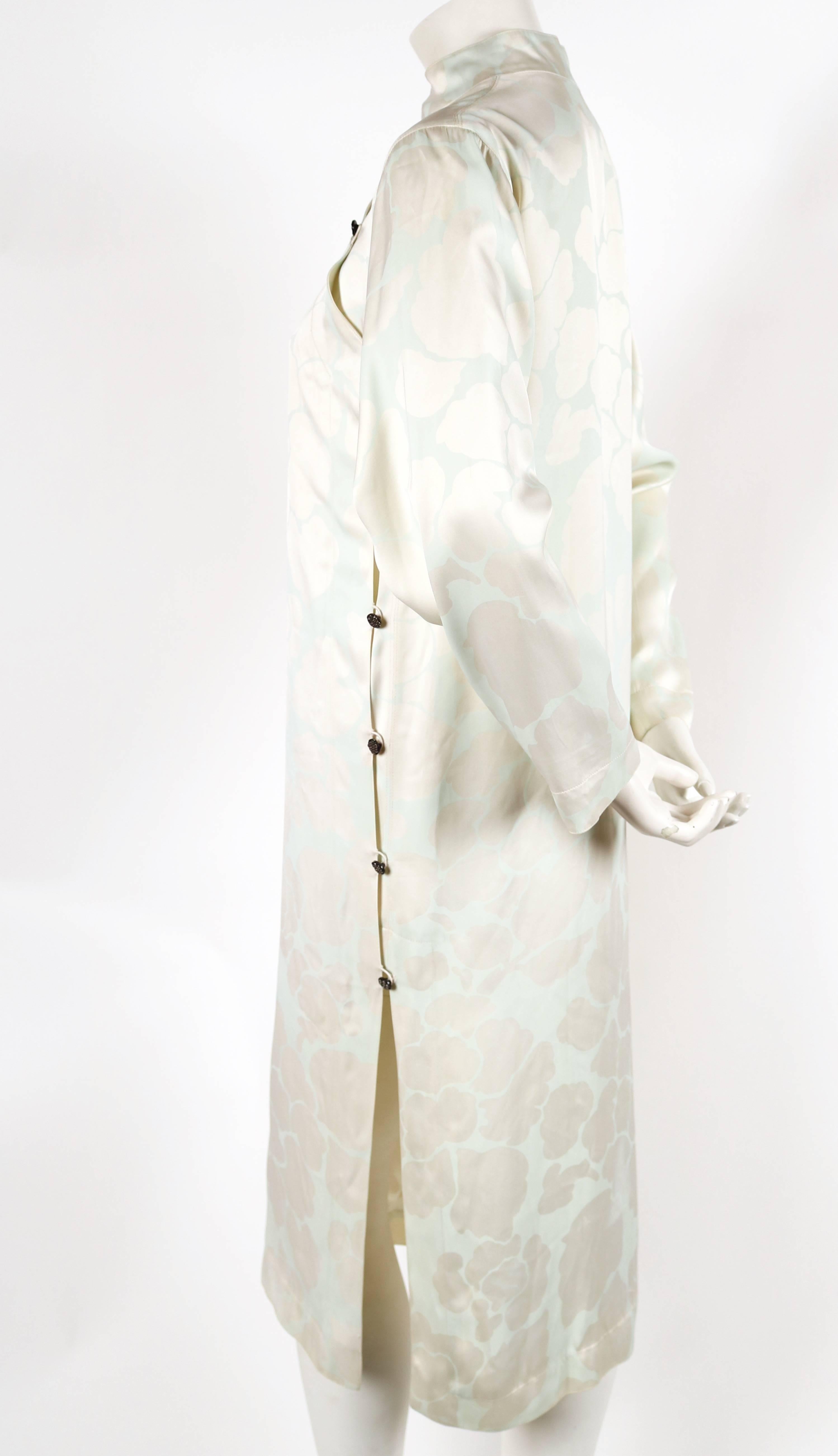 Unusual screen printed pale eau de nil on ivory silk with a slight blue undertone, Cheongsam dress with mandarin long sleeves from Yves Saint Laurent rive gauche dating to the 1970's. French size 36. Approximate measurements: 16