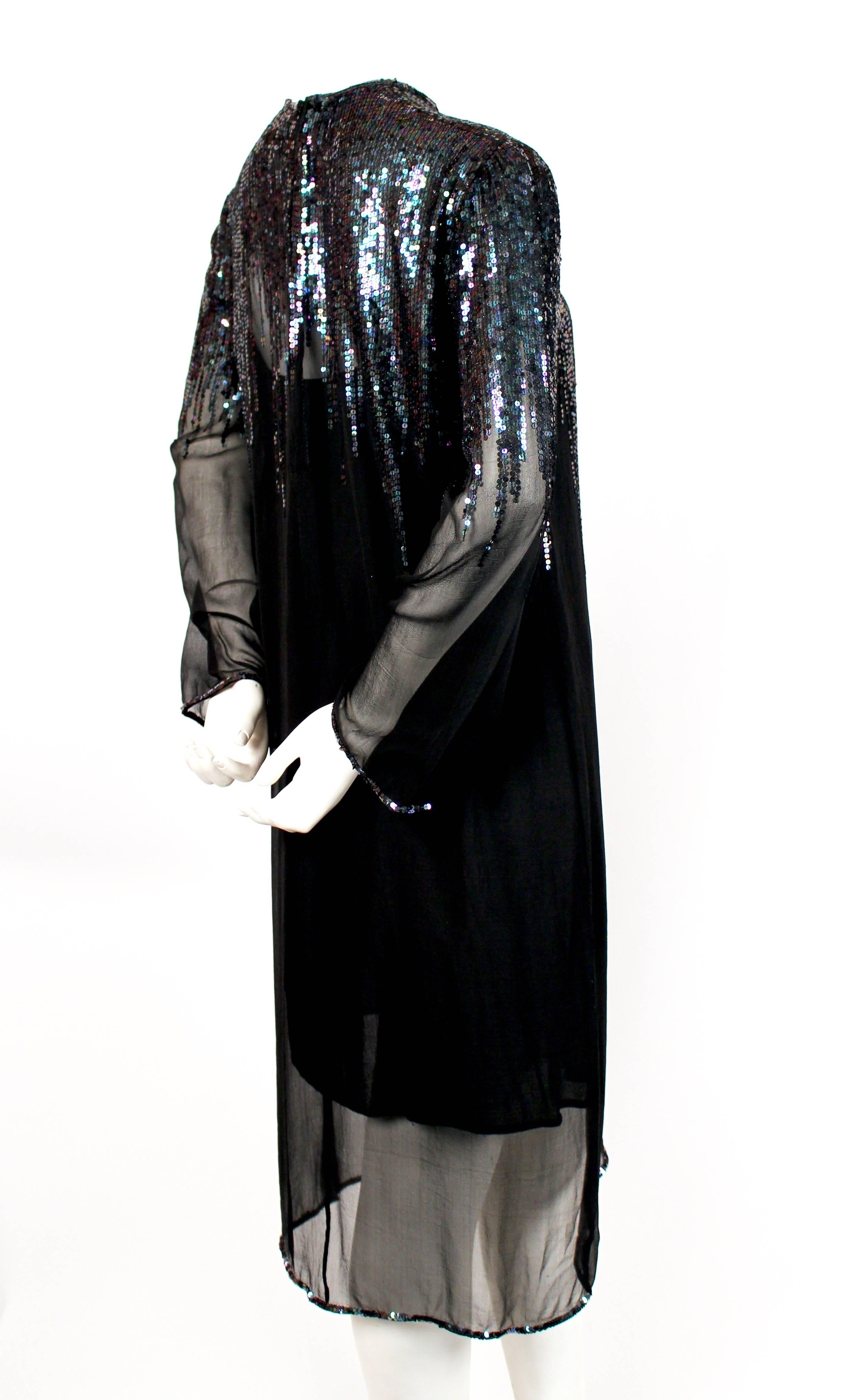 
Jet black sheer silk dress with sequins from Halston dating to the late 1970's. Dress slips over the head and secures with a hook/eye closures at back of neck. No size is indicated however this dress best fits a US 2-6. Approximate measurements: