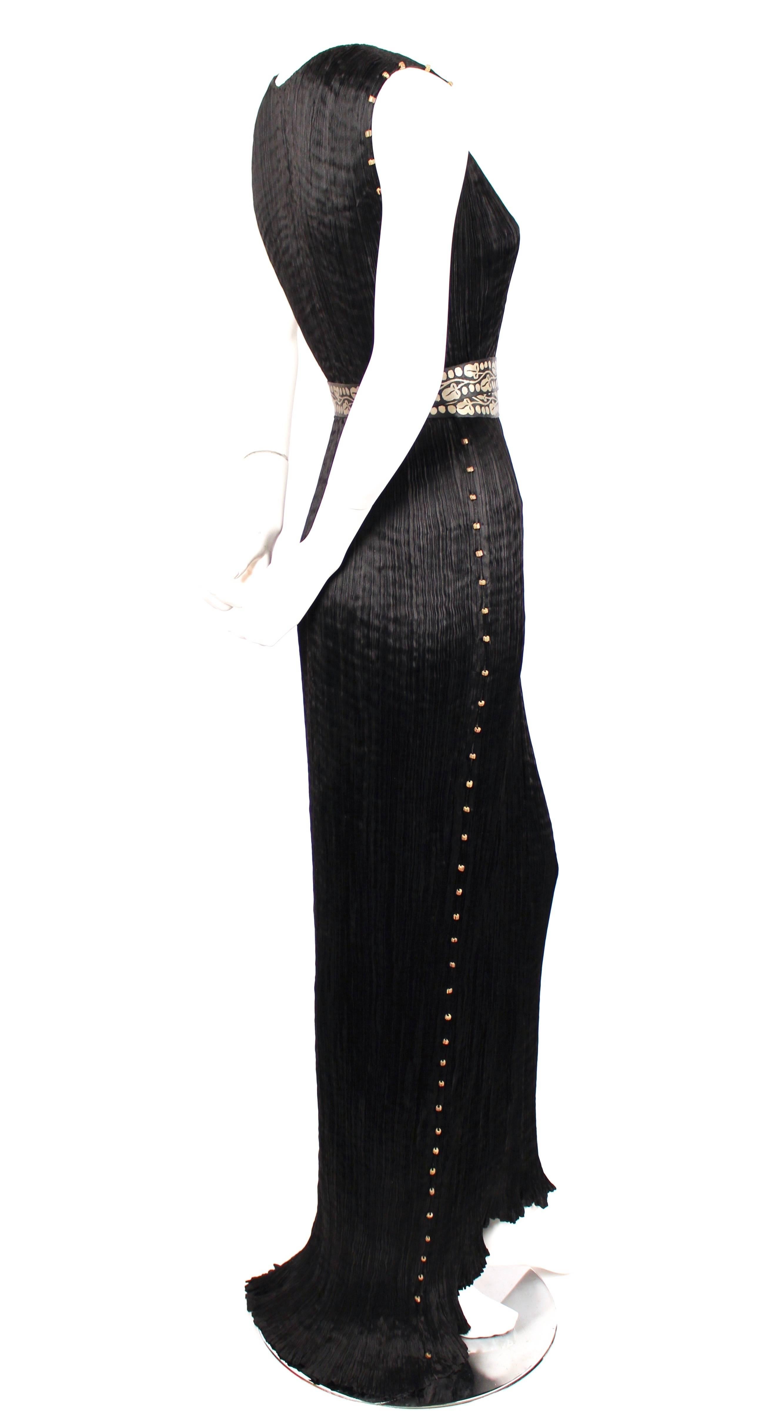 Jet black pleated silk 'Delphos' gown with Venetian striped glass beads and stamped gold silk belt from Mariano Fortuny dating to the 1930's. Fits a variety of sizes due to the pleated construction however this has been photographed on a size 2