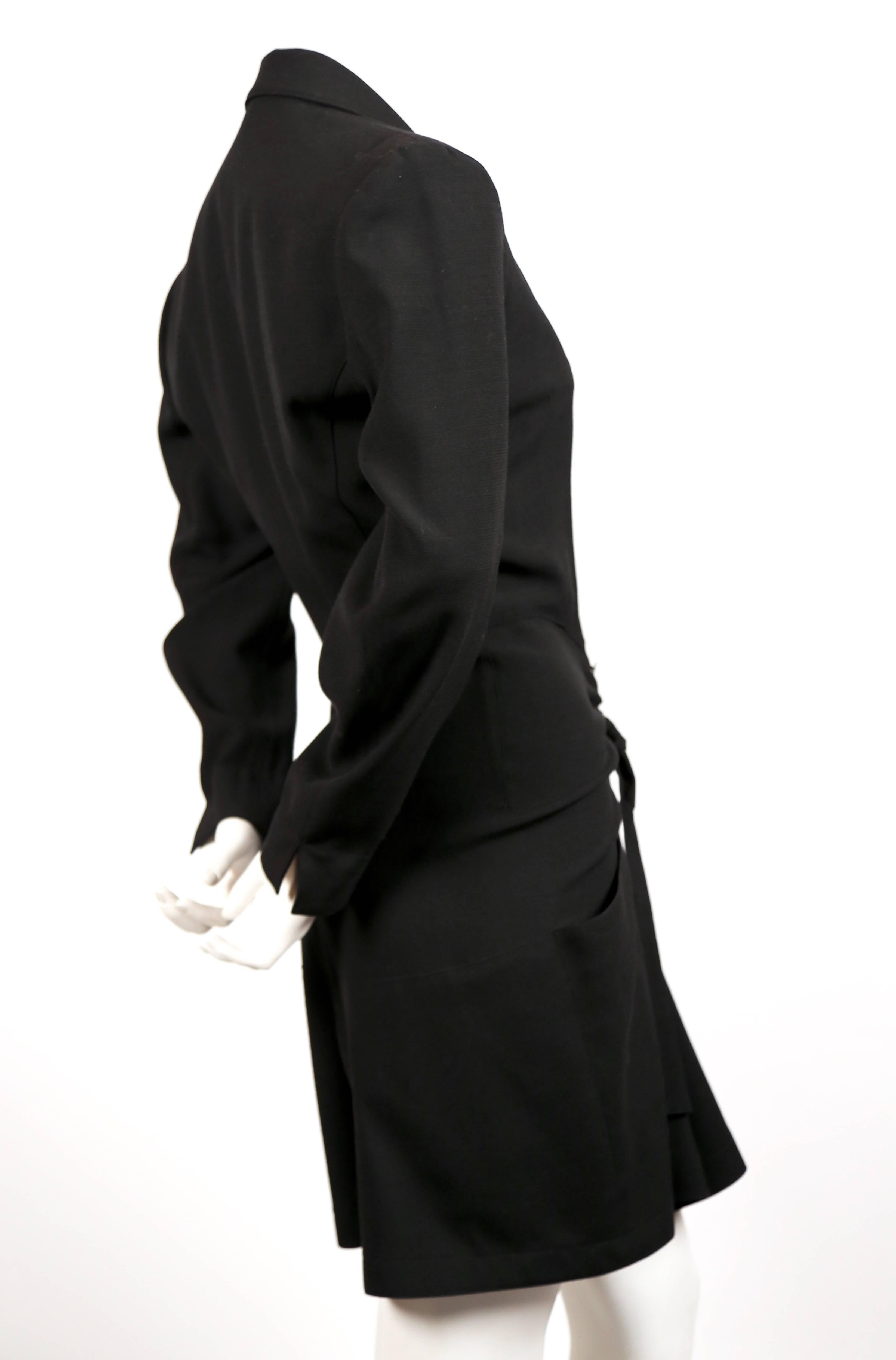 Black romper suit designed by Azzedine Alaia dating to spring of 1989 as seen on the runway. Labeled a FR 38. Approximate measurements: shoulders 15.5