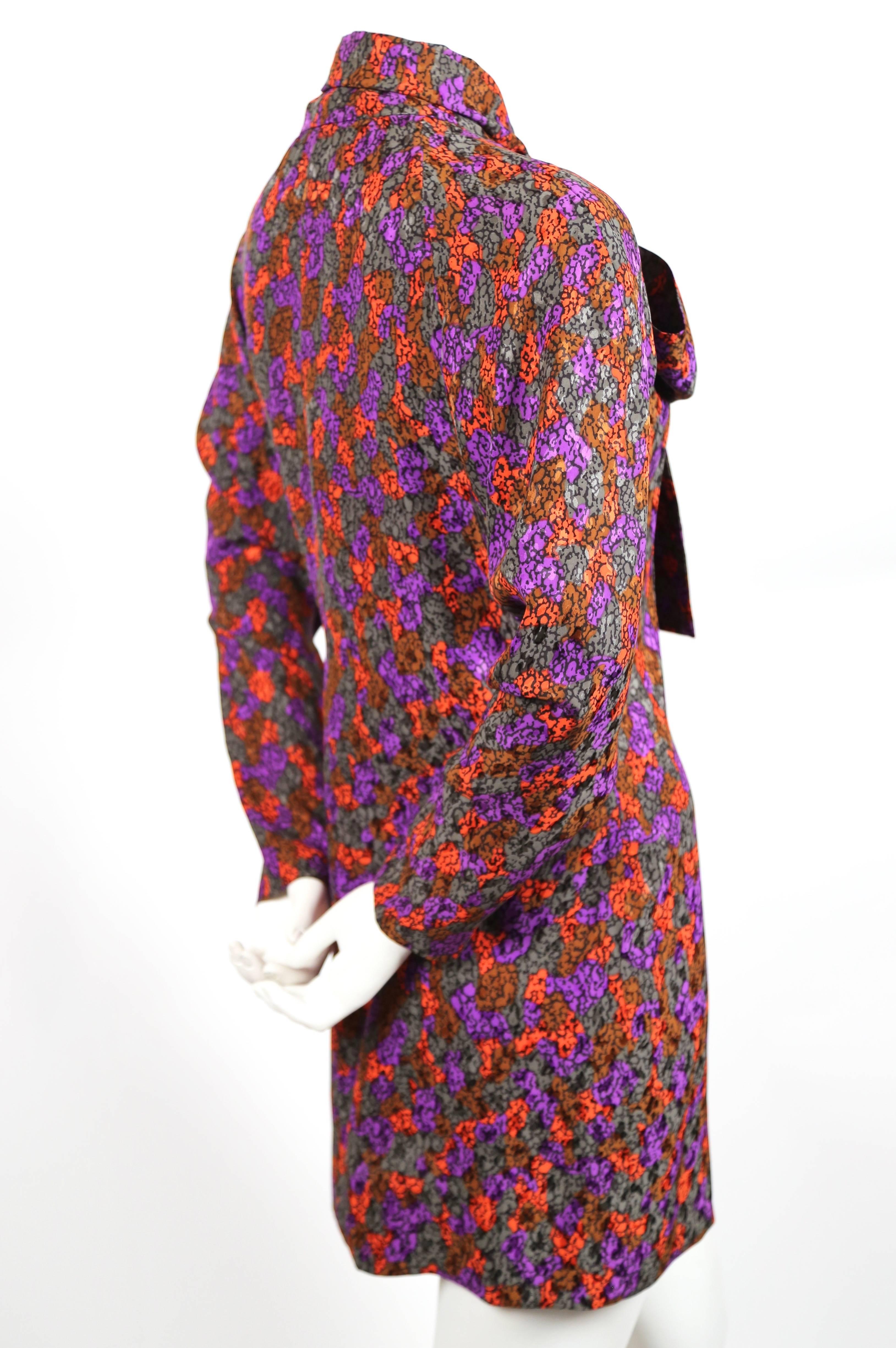 Vivid abstract printed silk mini dress with pussy bow tie from Yves Saint Laurent dating to the late 1970's, early 1980's. No size is indicated however this would best fit a US 4-6. Approximate measurements: bust 38", waist 35", hips