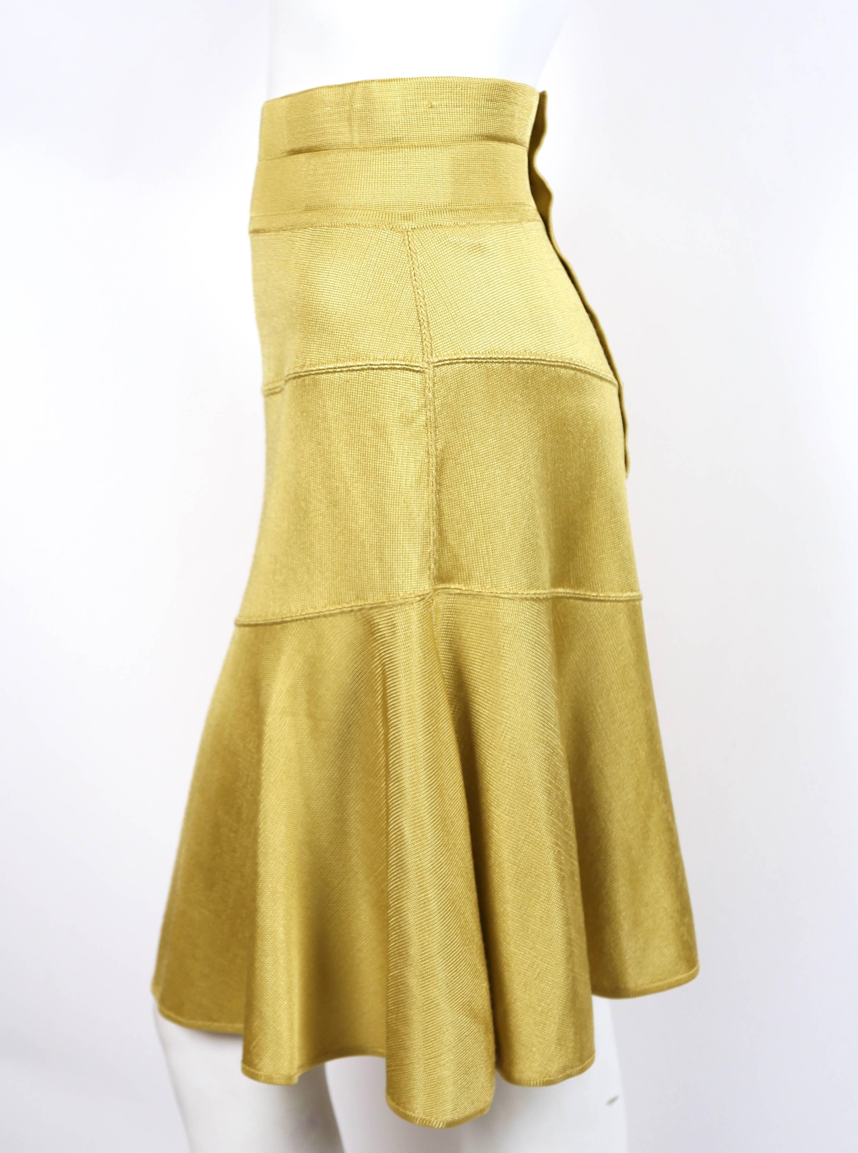 Yellow seamed skirt with high waist and center slits at front and back from Azzedine Alaia dating to the 1980's. Size 'S'. Approximate measurements: waist 25