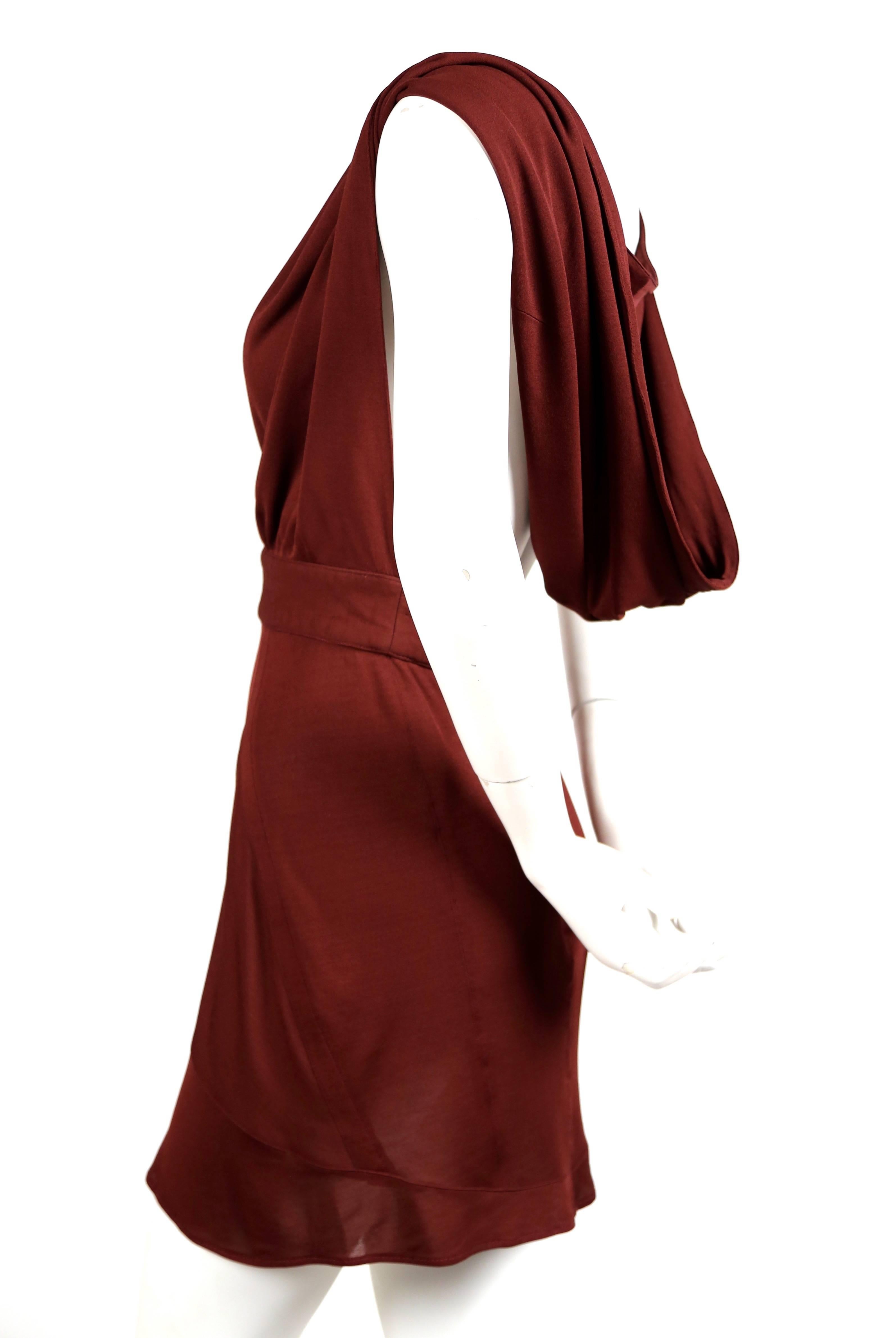 Very rare backless burgundy jersey dress with hood from Azzedine Alaia dating to 1990. No size label however this would best fit a modern U.S. 4. Approximate measurements: waist 26