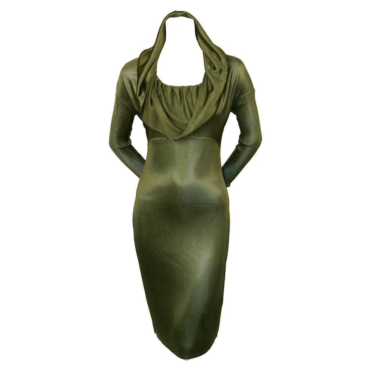 Very rare olive green hooded dress from Azzedine Alaia dating to 1986. 'Hood' can be draped for a more conventional look. Arms are made of a contrasting ribbed wool and are very long and narrow. Best suited for a size small or medium. Approximate
