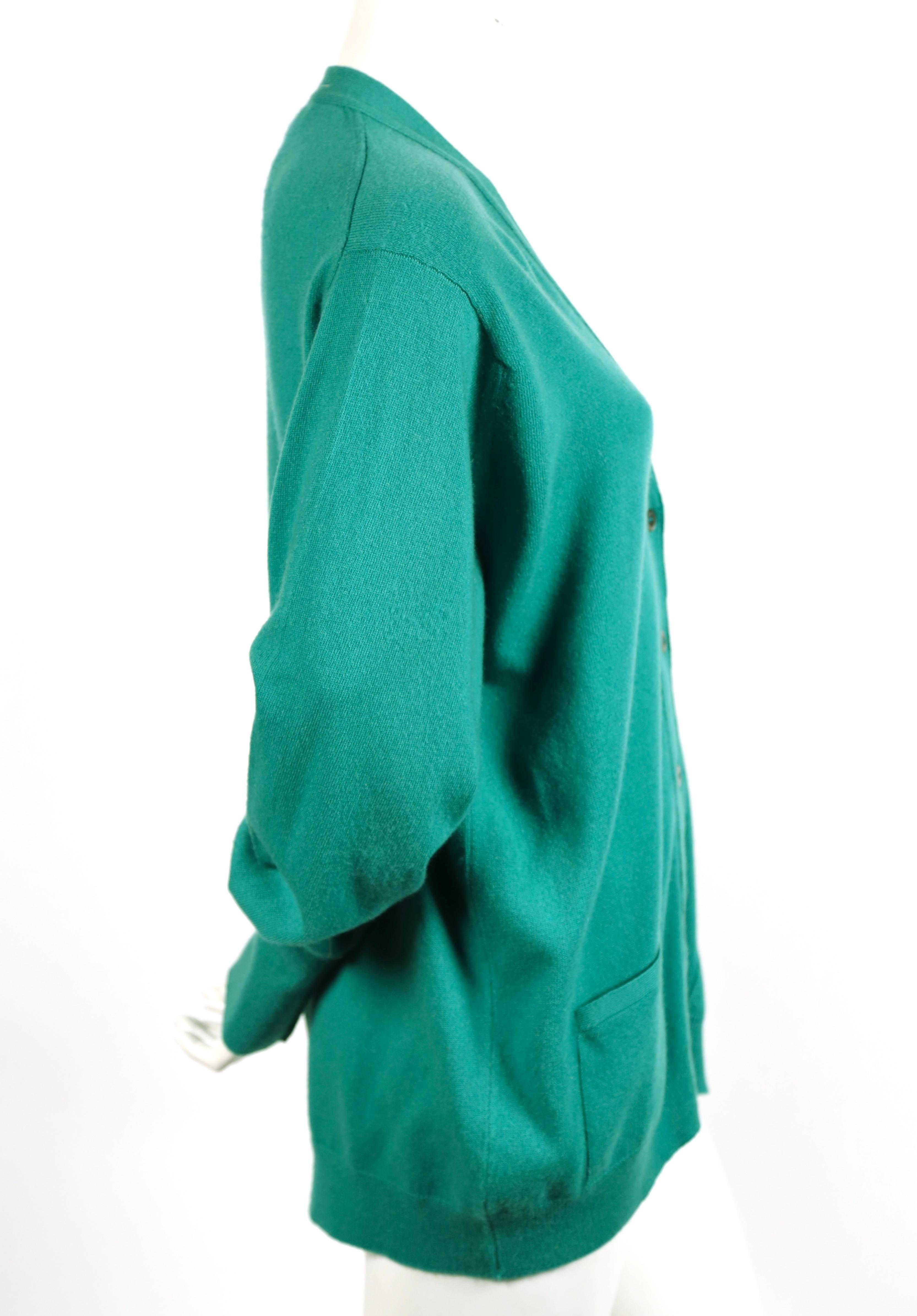 Green cashmere cardigan sweater designed by Hermes dating to the 1980's. Size 44. Approximate measurements: shoulder 22