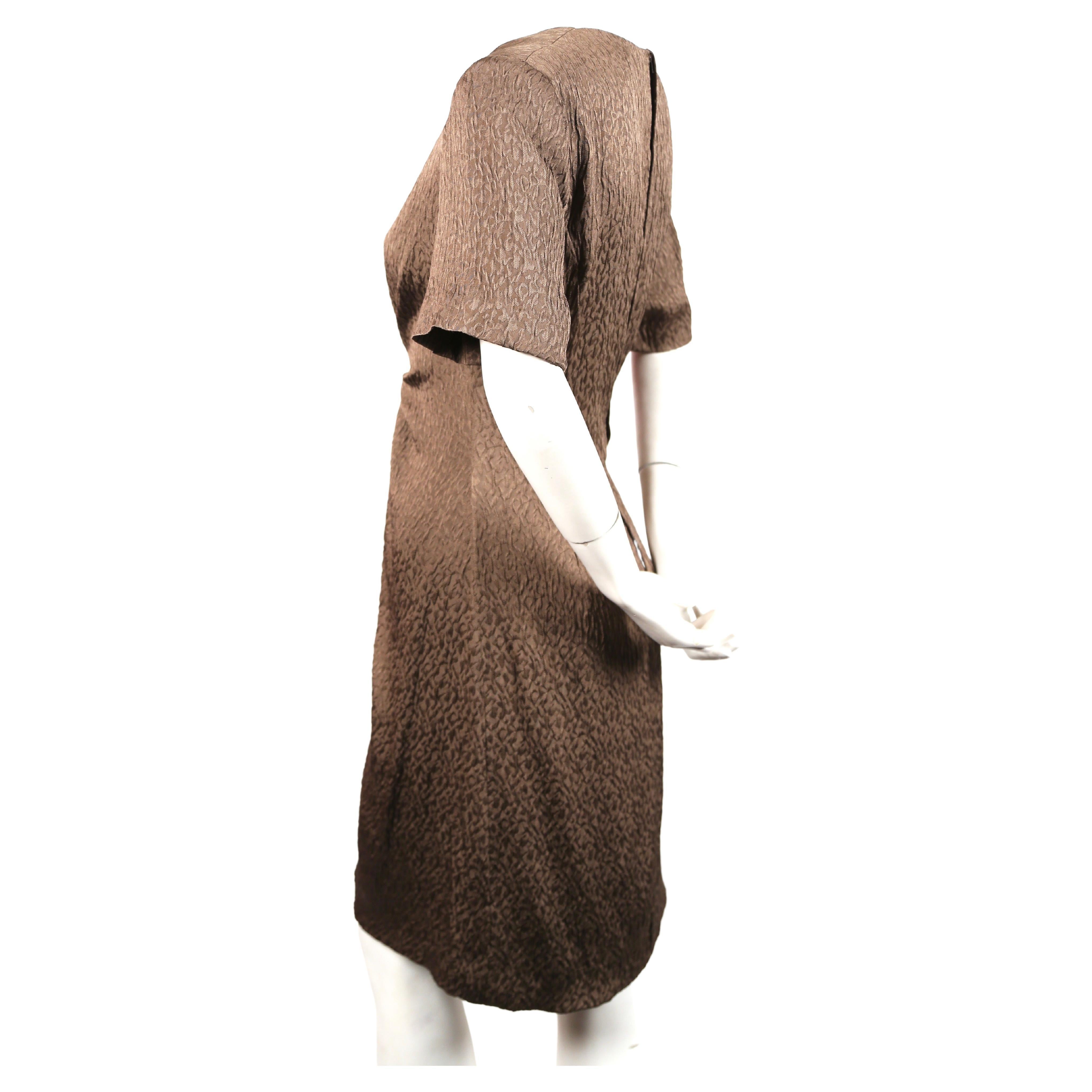 Textured taupe silk dress with flattering gathered center by Andre Laug dating to the early 1970's. Best fits a US 4 or 6 (interior waistband which can easily be removed measures approximately 25-25.5