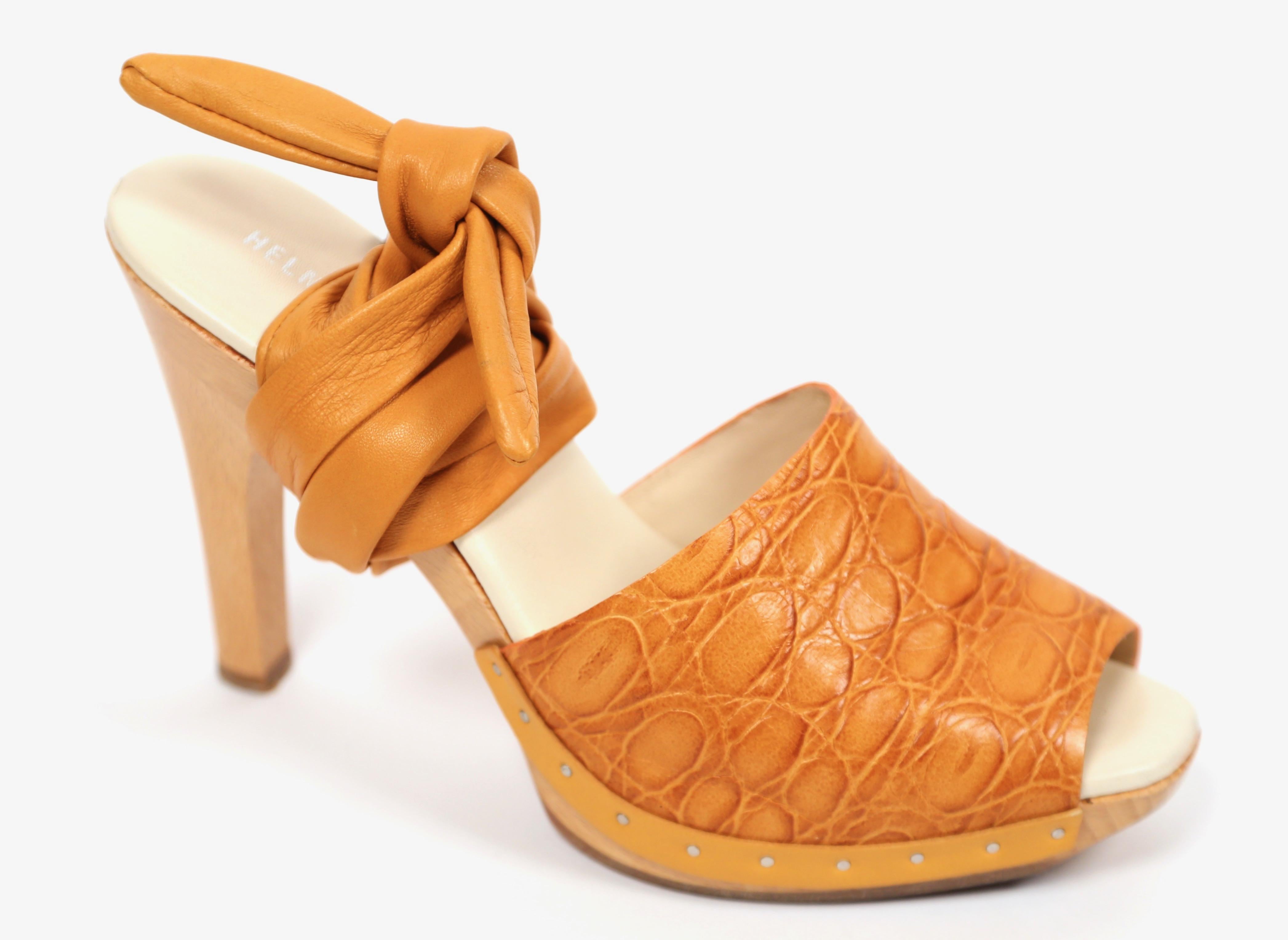 Golden-orange embossed leather platforms with silver studs and ankle straps designed by Helmut Lang dating to the 1990's. Heels are labeled an Italian size 37.5 which best fits a US 7 or 7.5. Insoles measure approximately: 9.76