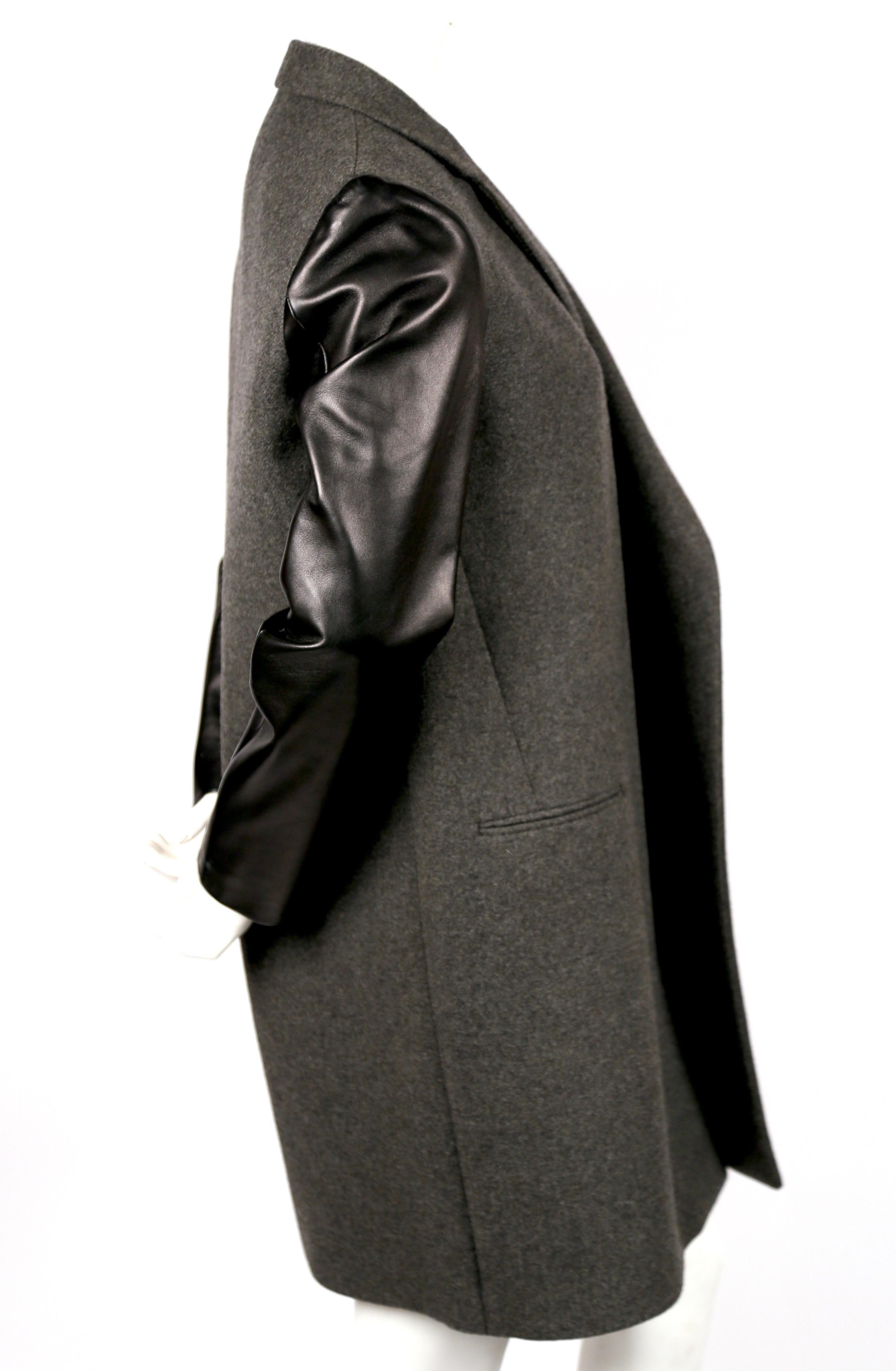 Charcoal grey crombie coat with black lambskin leather sleeves designed by Phoebe Philo for Celine. Labeled a French size 40 which best fits a size S or M. Approximate measurements: shoulder 15.5