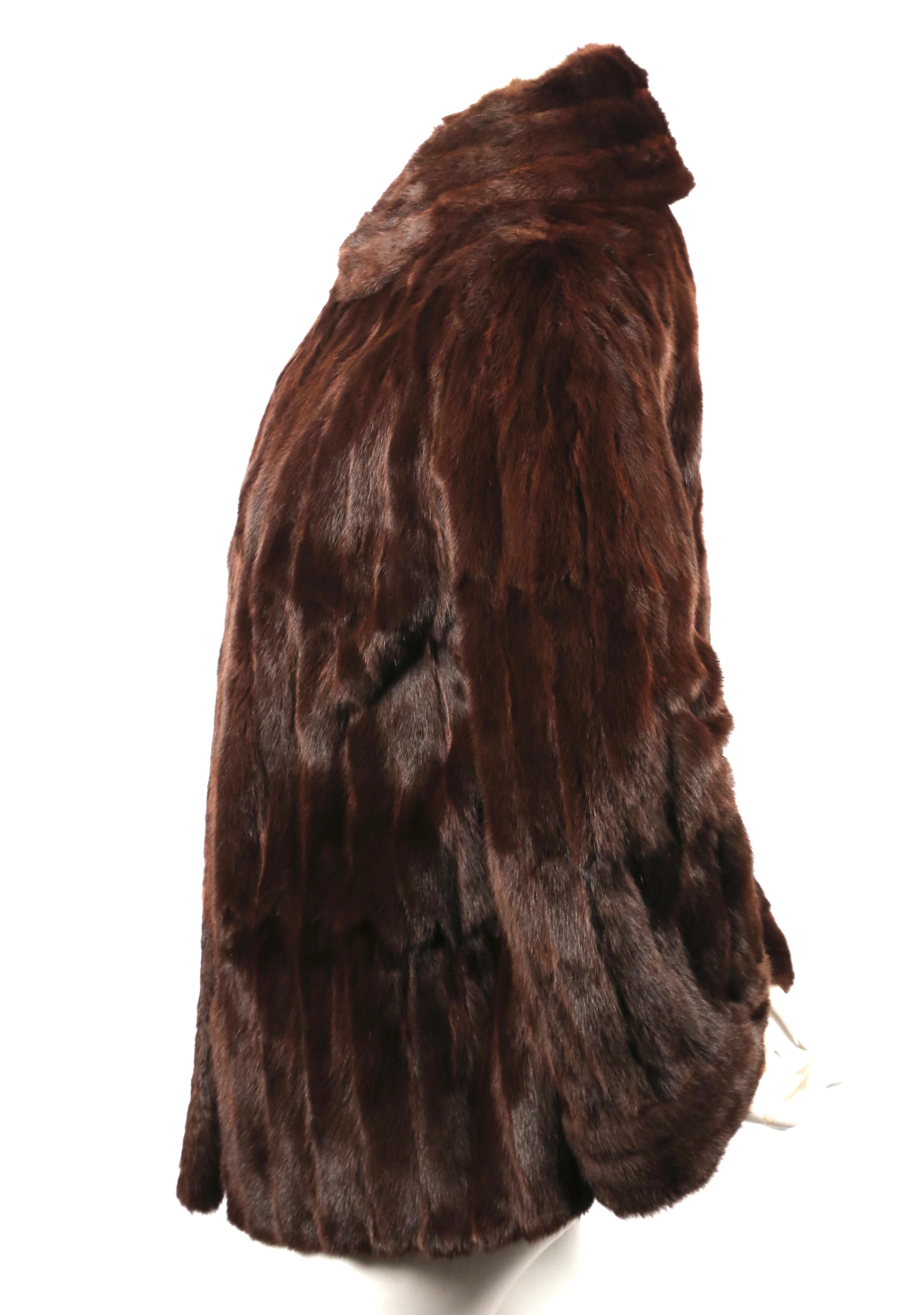Rich brown French lapin fur coat from Thierry Mugler dating to the early 1990's. Fits a size small or medium. Hook closure. Fully lined. Made in France. Very good condition.
