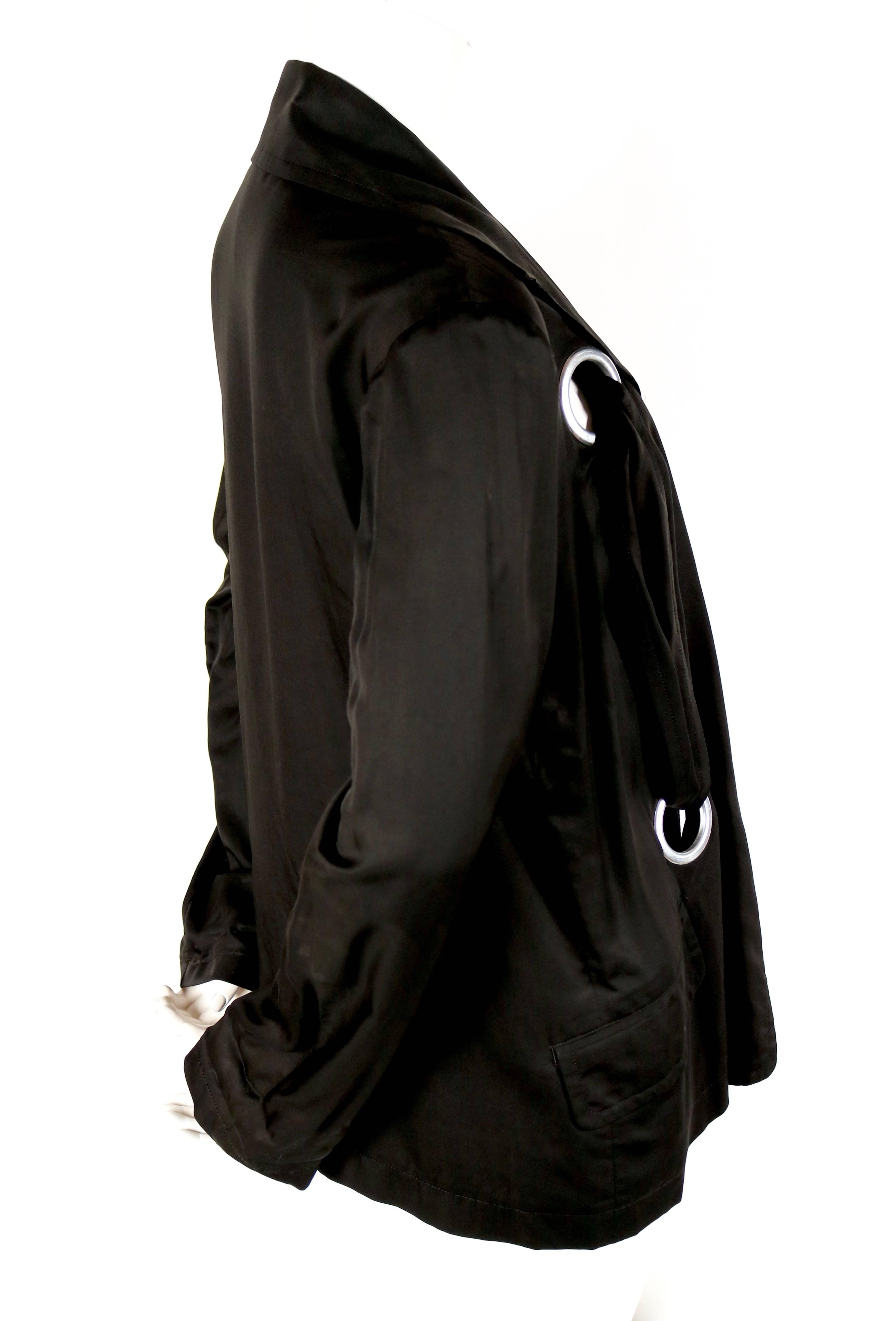 Jet black jacket with large silver grommets from Yohji Yamamoto exactly as seen on the runway for spring of 2004 . Labeled a Japanese size '1' which fits a US small or possibly a medium. Approximate measurements: shoulders 16