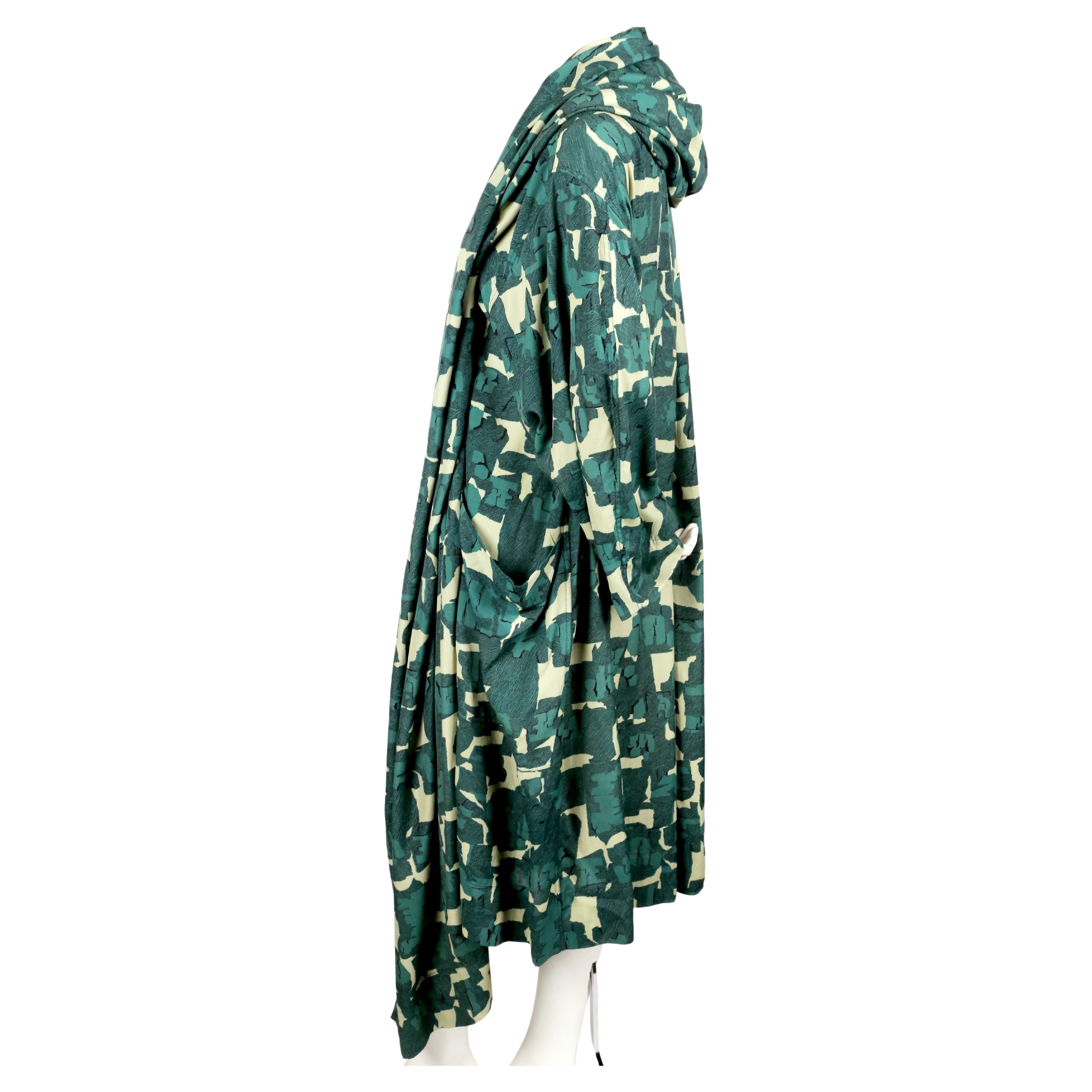 Very rare, abstract-printed kimono with large hood and wrap around pockets designed by Azzedine Alaia with artwork by Christoph Von Weyhe dating to 1985 as seen on the runway. French size 38 however this piece is very oversized so it will fit most