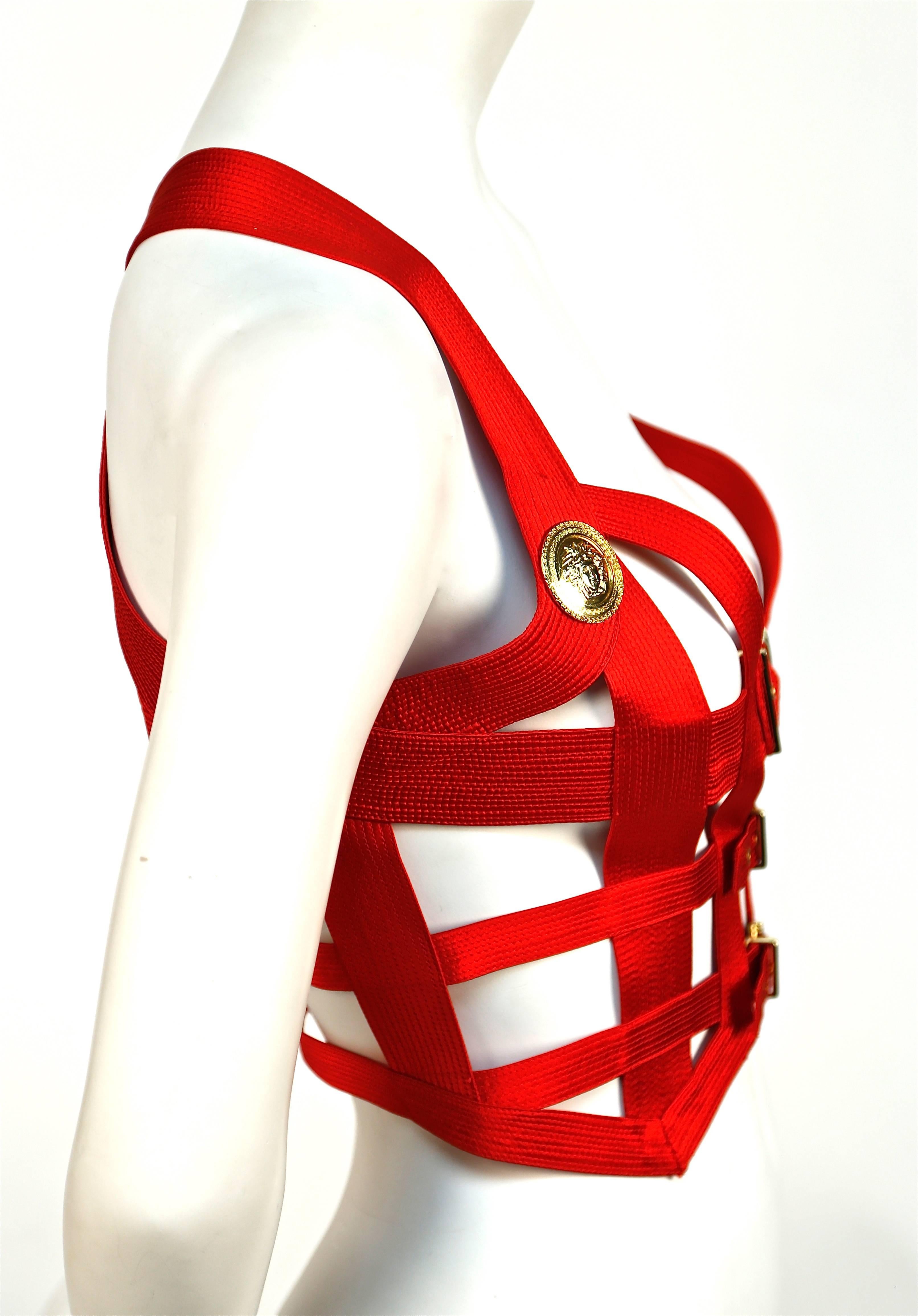 Iconic and very rare Gianni Versace Couture red silk topstitched bondage harness bodice with gold-toned Medusa embossed hardware designed by Gianni Versace exactly as seen in the Fall 1992 Bondage runway collection.  Labeled an Italian size 42 which