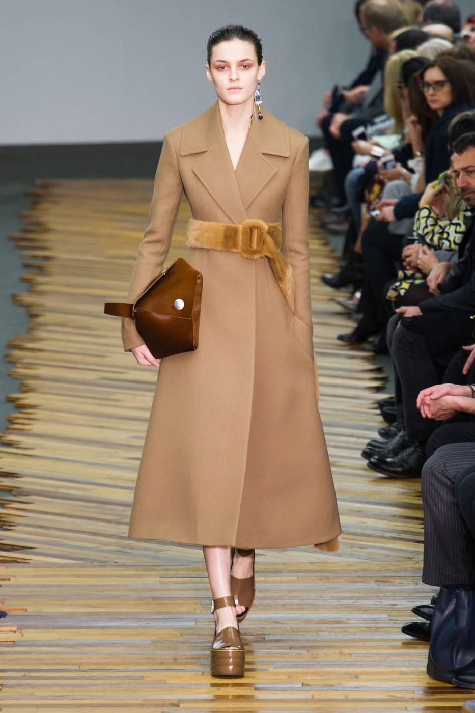 Camel wool gaberdine coat with narrow arms and flared hemline designed by Phoebe Philo for Celine exactly as seen on the fall 2014 runway. French size 40 which fits a US 6-8. Made in Italy. Fully lined. Pockets at hips. New with tags. Original