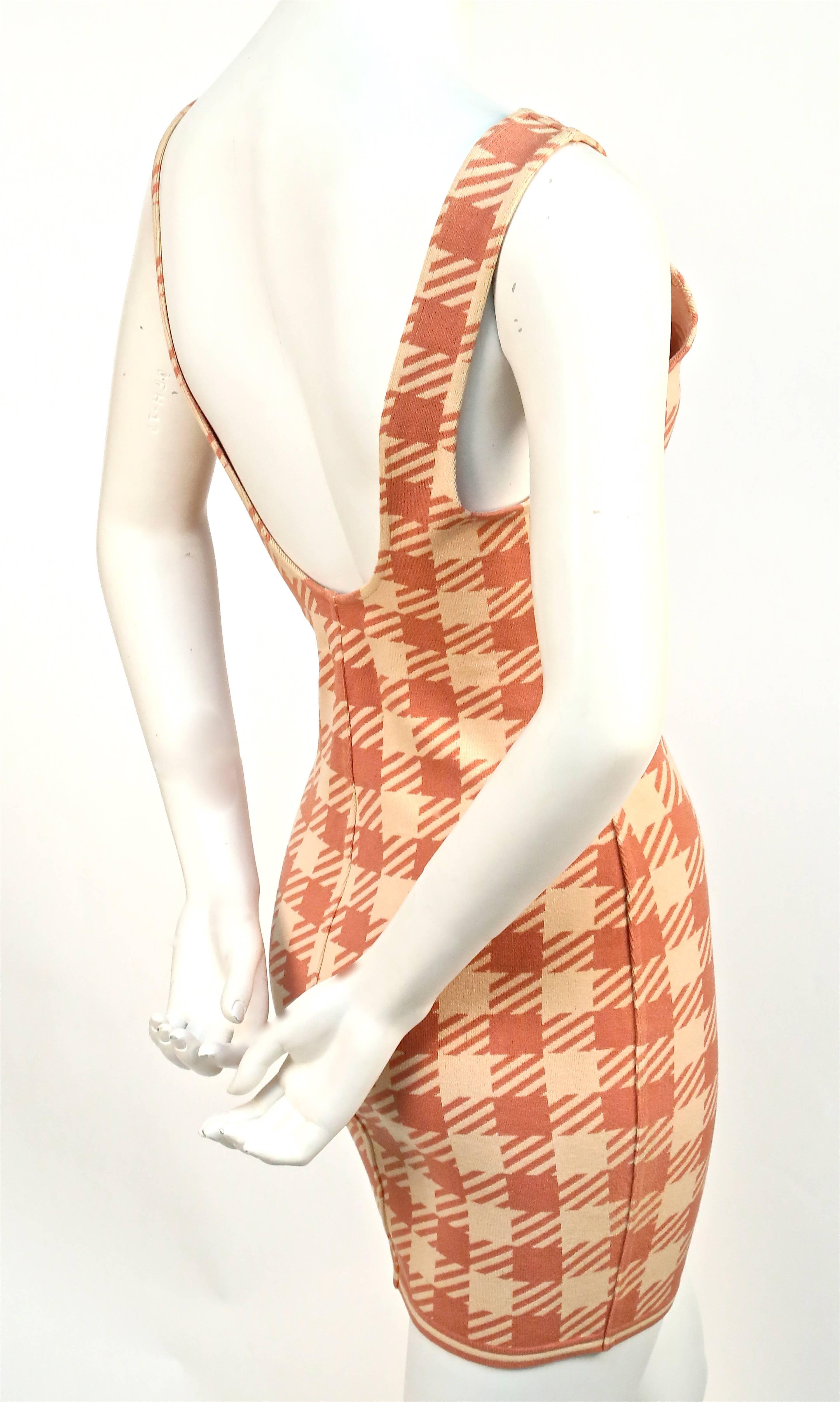 Very rare and well documented houndstooth check dress designed by Azzedine Alaia dating to the spring of 1991 'Tati' collection. Fabric inspired by the iconic checked awnings of the Parisian discount chain store 'Tati'. Labeled a size 'M'. Dress