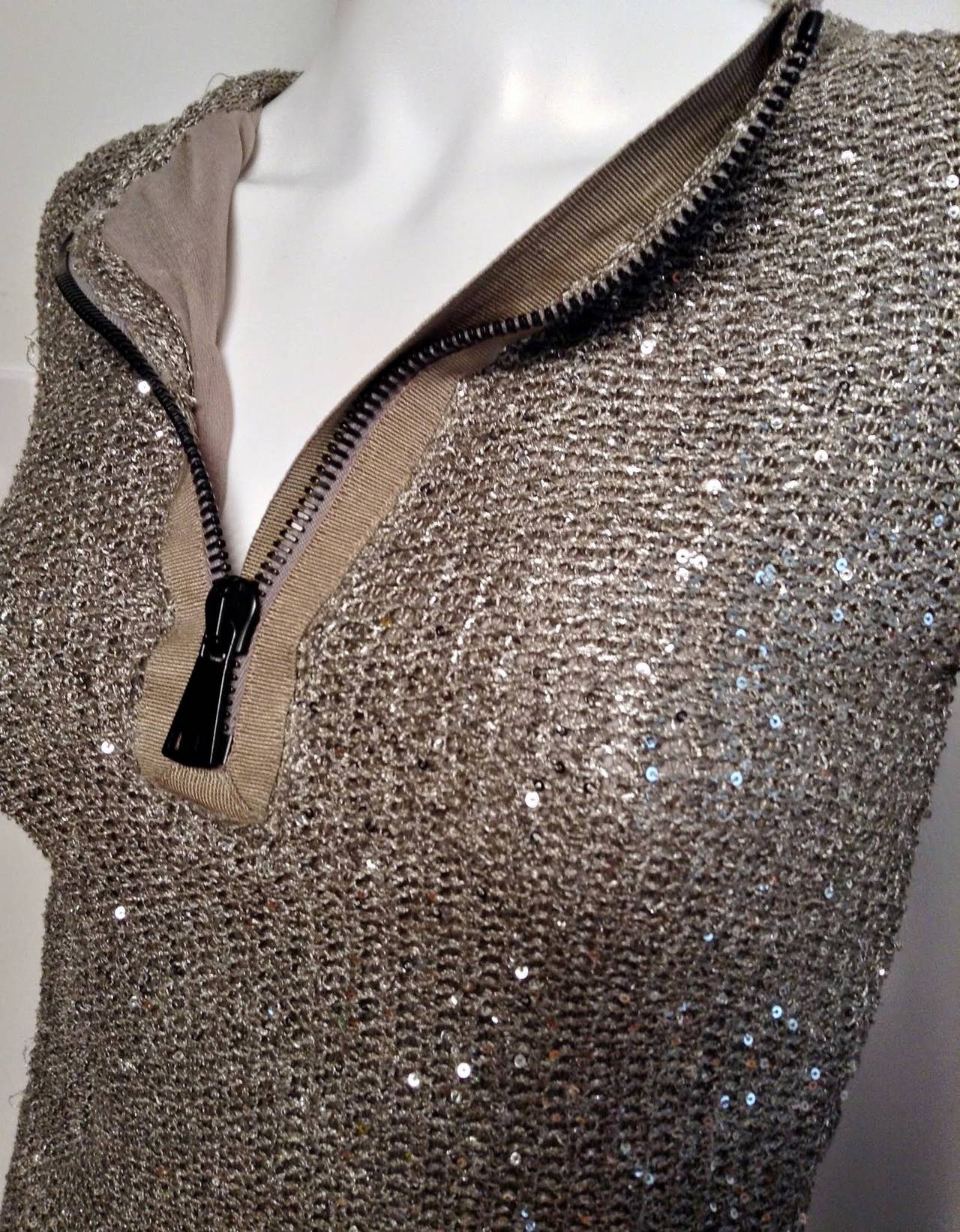 Sequins and mesh done right! This Tom Ford beauty features a large exposed zipper at front. Zip open for deep-V, or closed for crew neck. Exposed side zip at sleeve. Tonal trim at zipper. Long sleeve. Pull over. Unworn. 

Measurements: 25