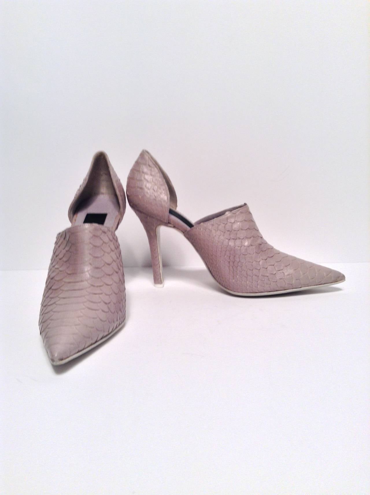 Add these Grey D'Orsay Pumps to your closet and renew your spring/summer wardrobe. Features a grey python-stamped leather upper and a self-covered heel. Pointed toe. White sole for a light and fresh finish. Slip On.

Measurements: 4.25