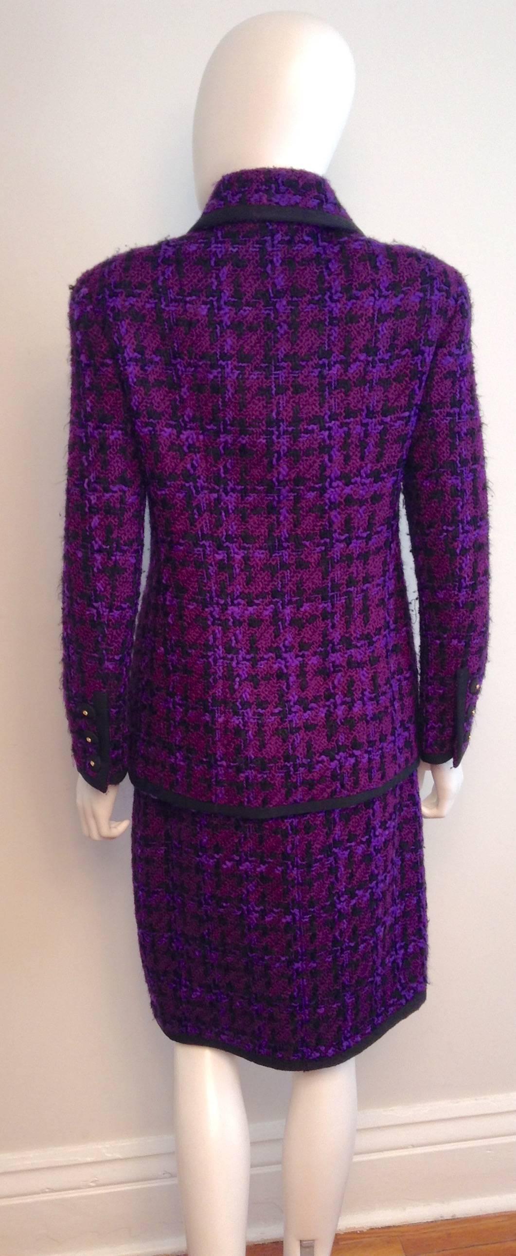 Multi-shades of purple are showcased in this cool Chanel Purple Tweed Skirt Suit. The jacket features two flat front pockets, long sleeves and black trim. Black silk covered buttons with small CC gold detailing decorate the suit. Button up closure.