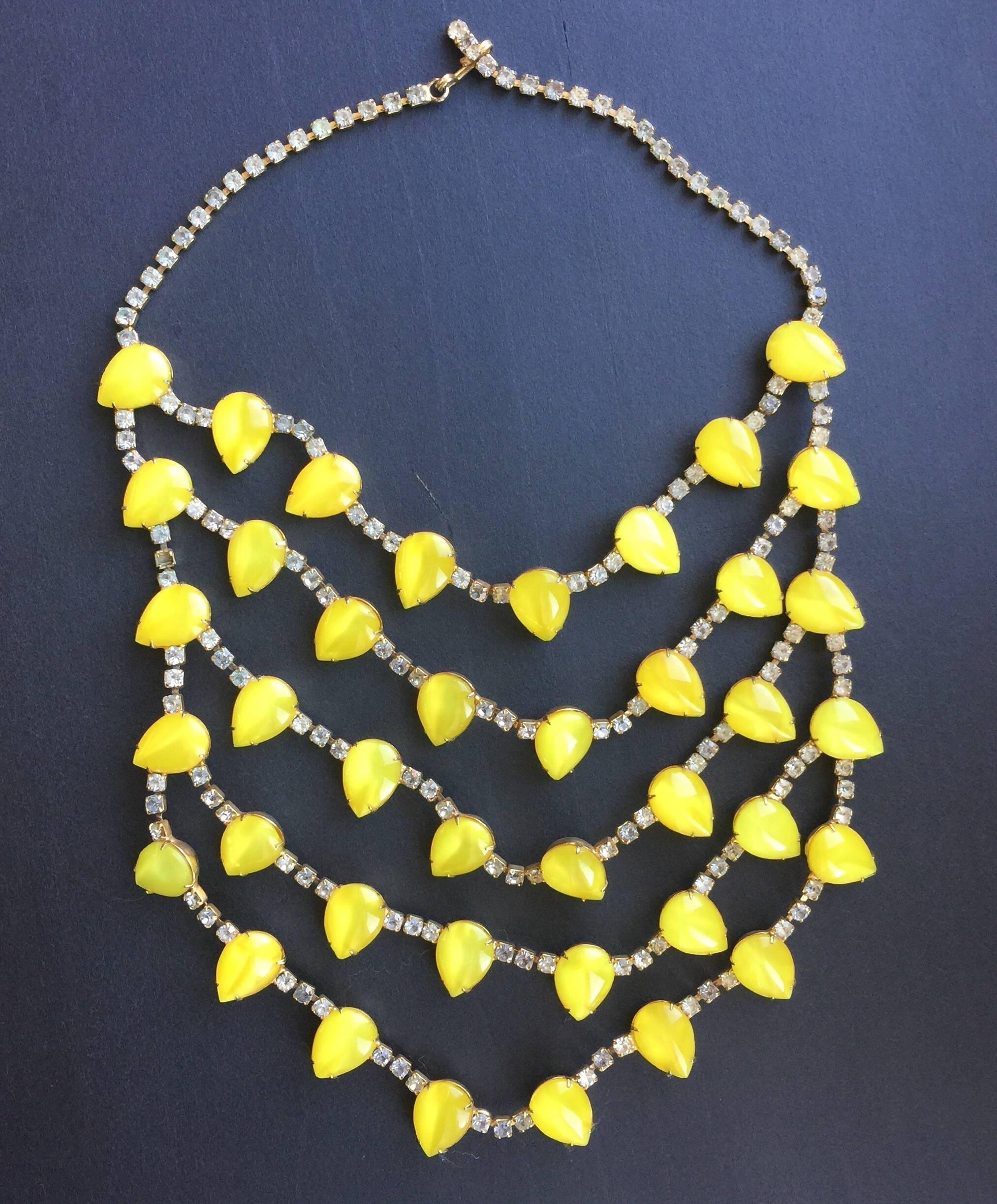 This brilliant tiered KJL necklace is made with neon citrine colored stones and crystal. It is from the late 1980s.  This beautiful necklace has 5 tiers of neon citrine colored stones and crystals. The bright yellow stones are teardrop shaped. The