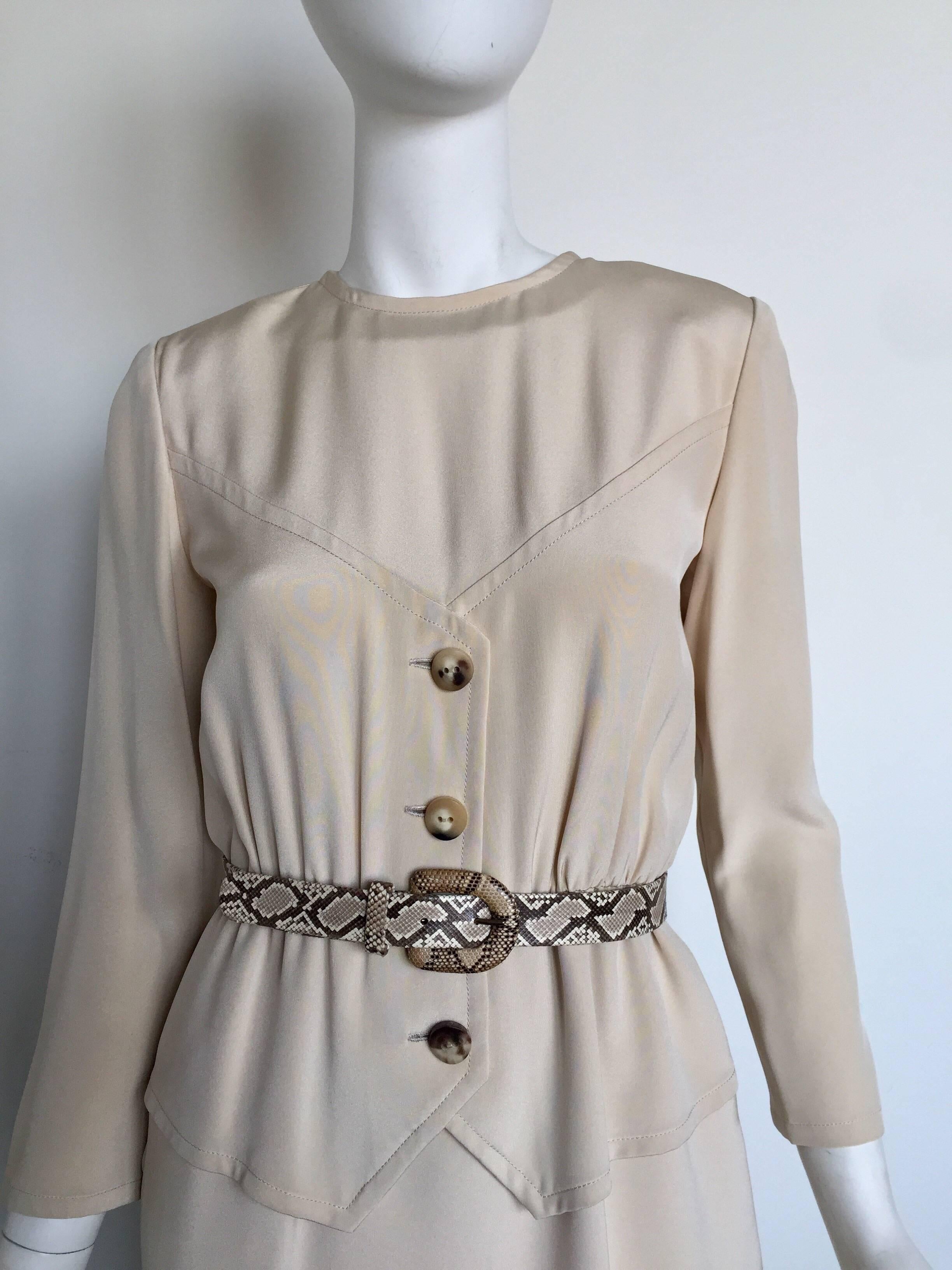 This Bill Bless dress and belt are from the 1980s. This long sleeved cream dress has a snakeskin matching belt to accent the waist. The dress is fully lined and has a hidden zipper back enclosure.  

BUST: 34