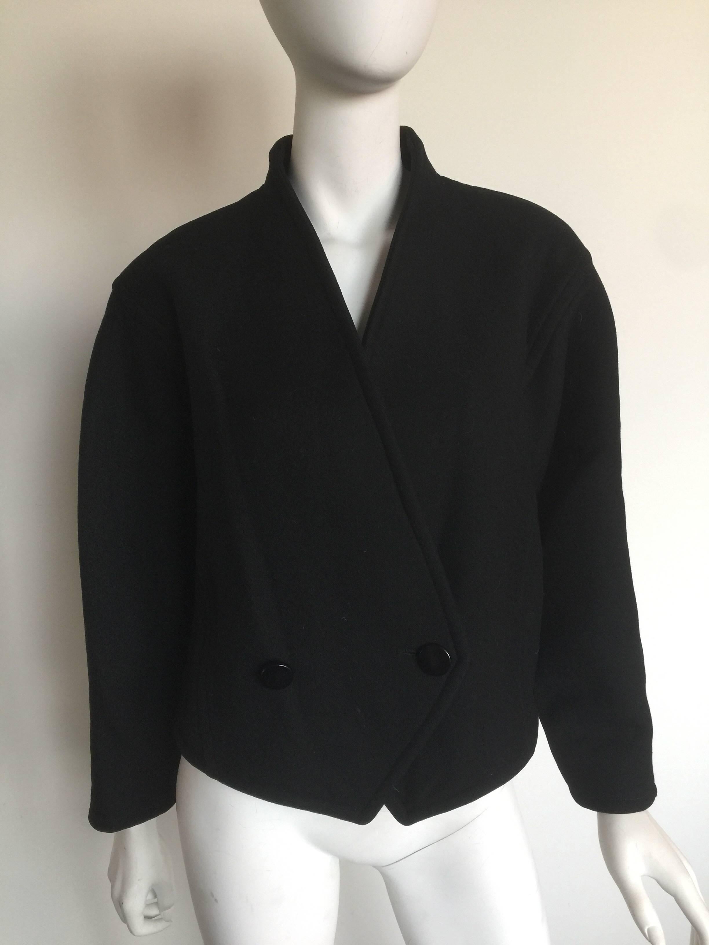 This cropped Courreges pea coat from the 1980's boasts a minimalistic structured silhouette, making it the ideal finisher for most ensembles.  It has two large round buttons for a double-breasted look and can be worn open or closed. The coat is