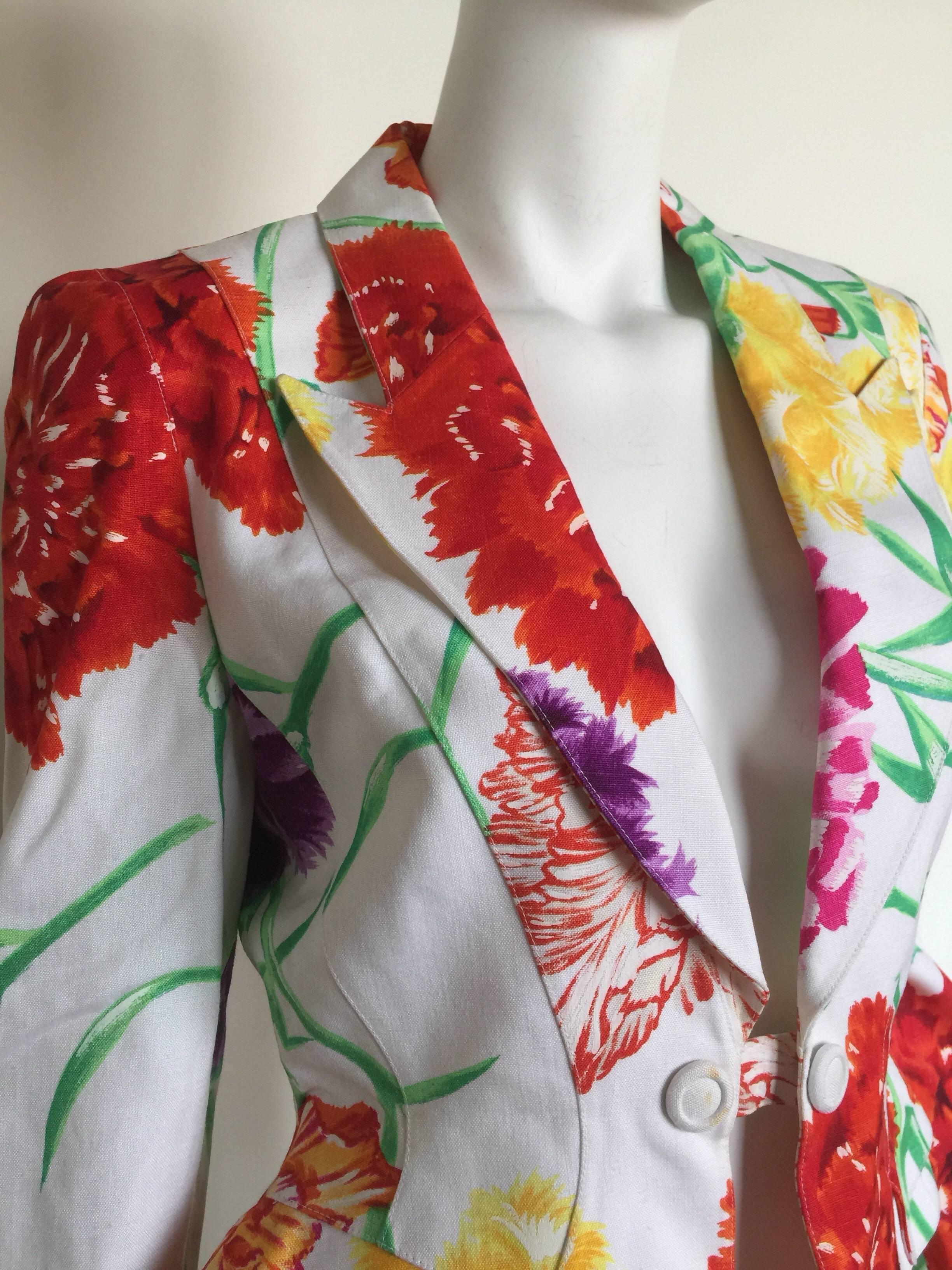 This Thierry Mugler blazer is from the 1980s.  This white floral linen blazer is an elegant statement piece. The floral print has brush strokes making it look like it was hand painted. Typical of Mugler, the jacket has interesting structured seam