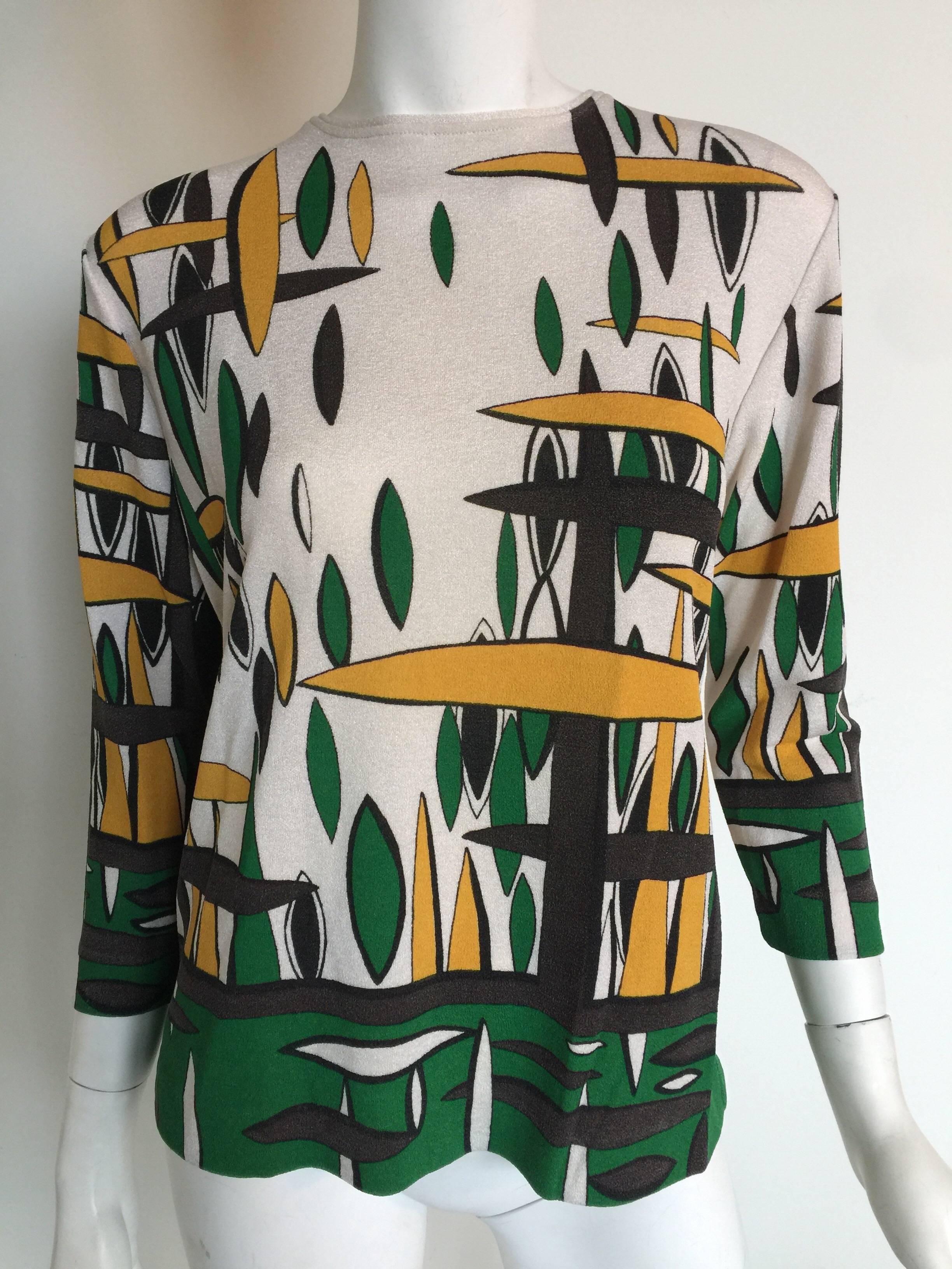 This 1970s polyester blend shirt has a cool mod print.  It is a great vintage top.
