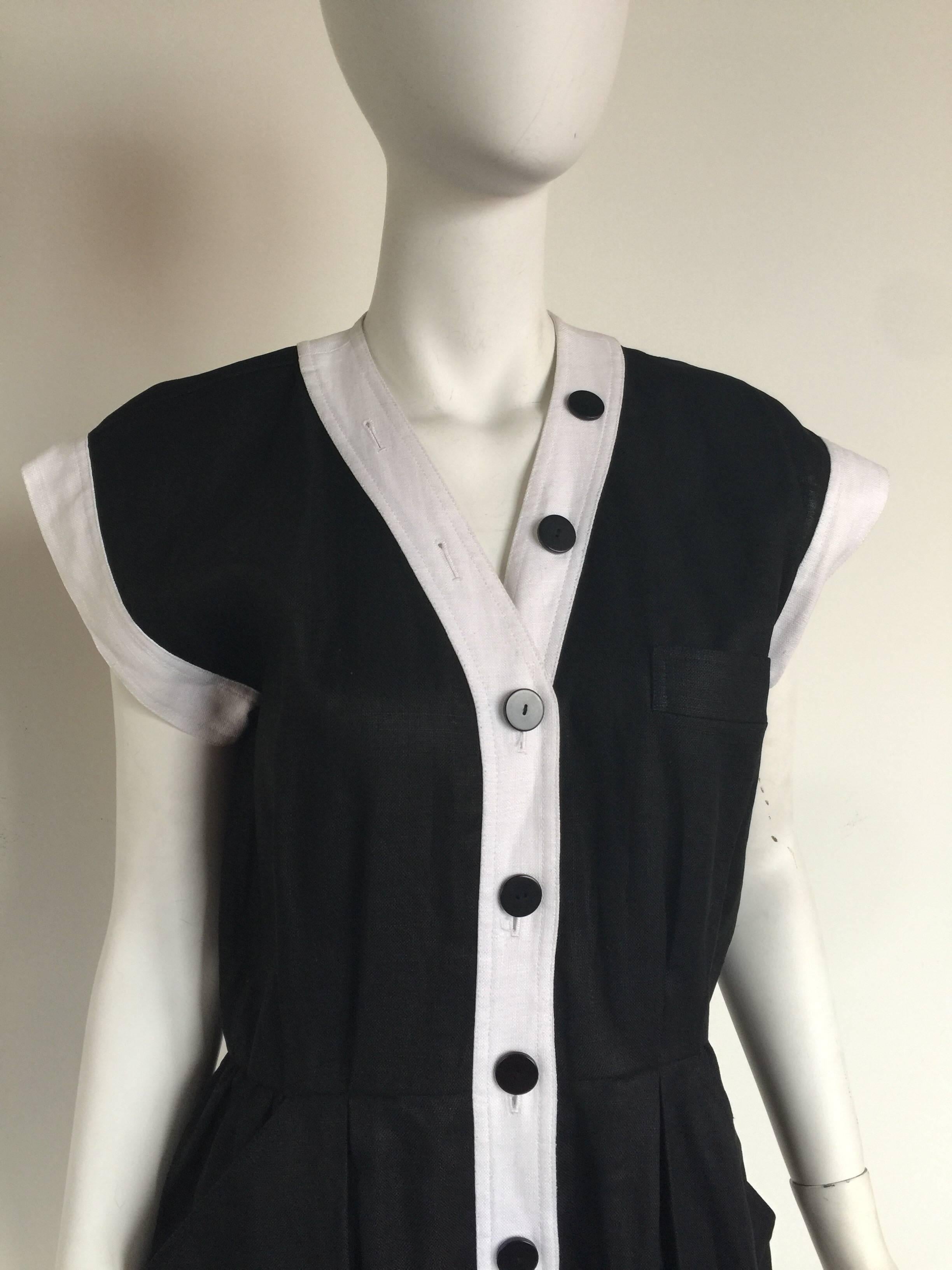 This black linenYSL dress has white pipping and black buttons down the collar and front of the dress.  It is marked a size 42 and is fairly true to size but please check measurements.  