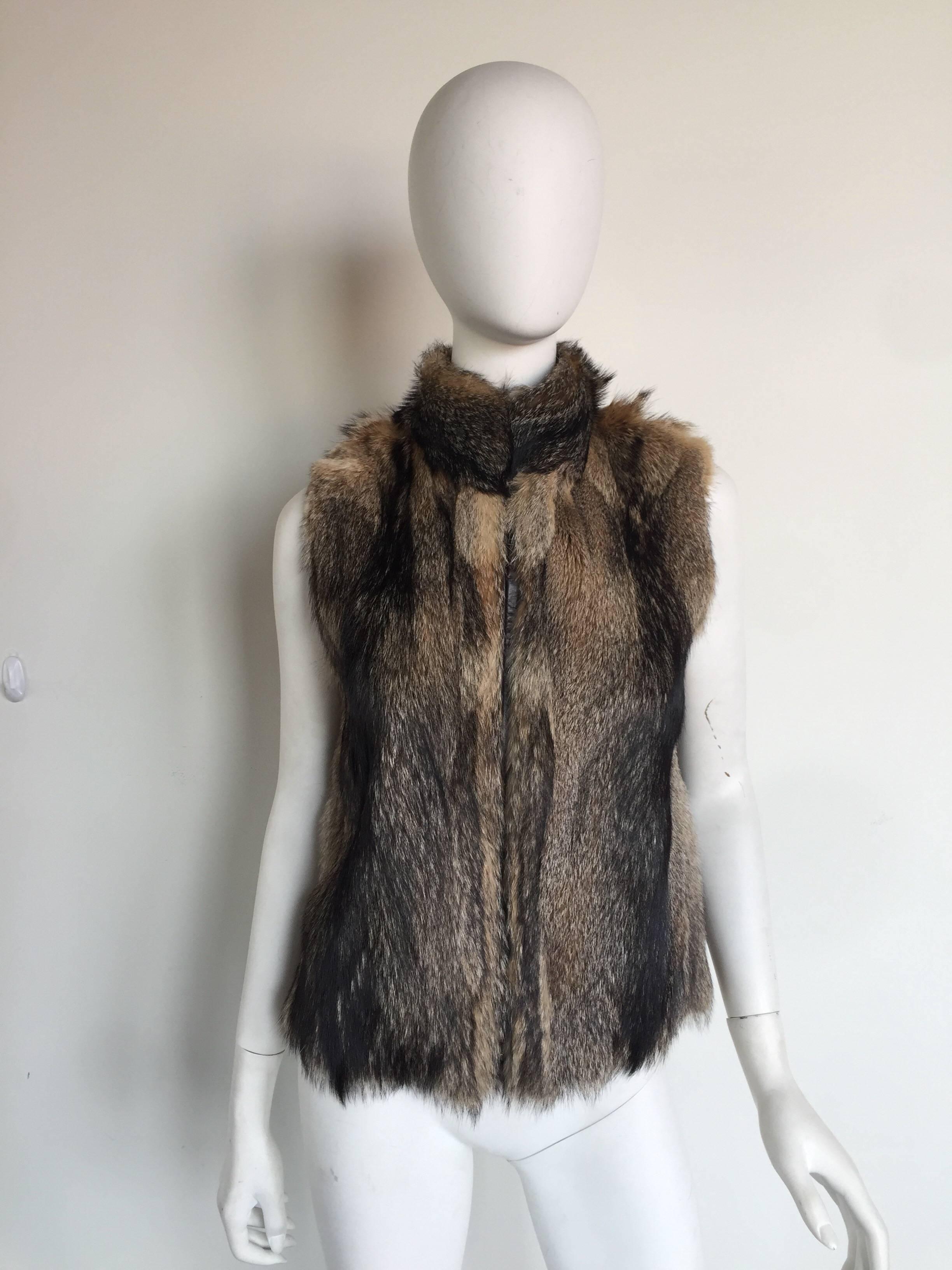 This fox fur vest is reversible with a chocolate brown leather interior.  It is in great condition.