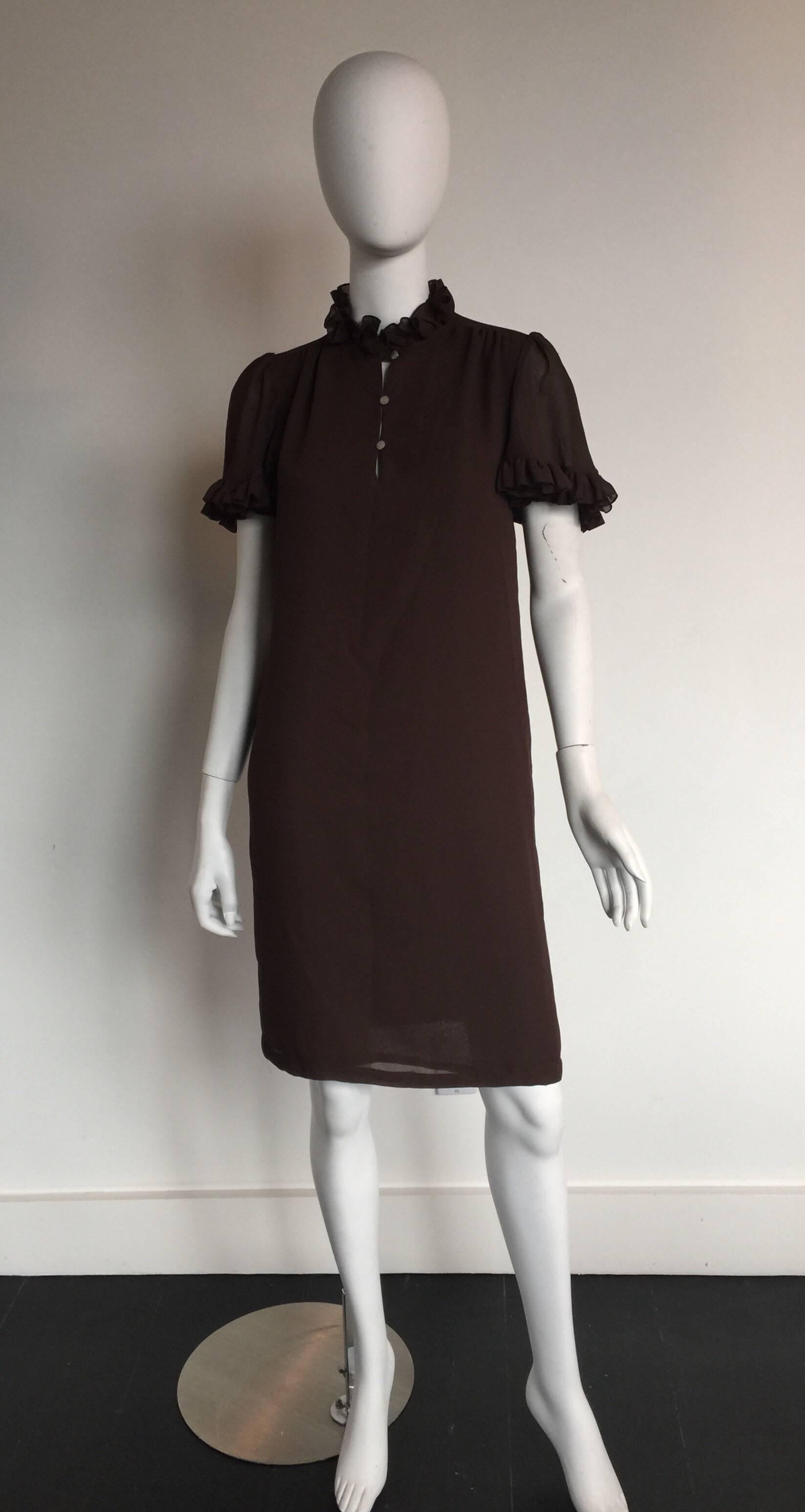 This Mr. Blackwell chocolate brown ruffle sleeve dress is from the 1970s.  It has three buttons in the front and has a babydoll cut.  It has an original Bullocks Wilshire from the LA boutique.  It has a forgiving cut so can fit a S/M.  
