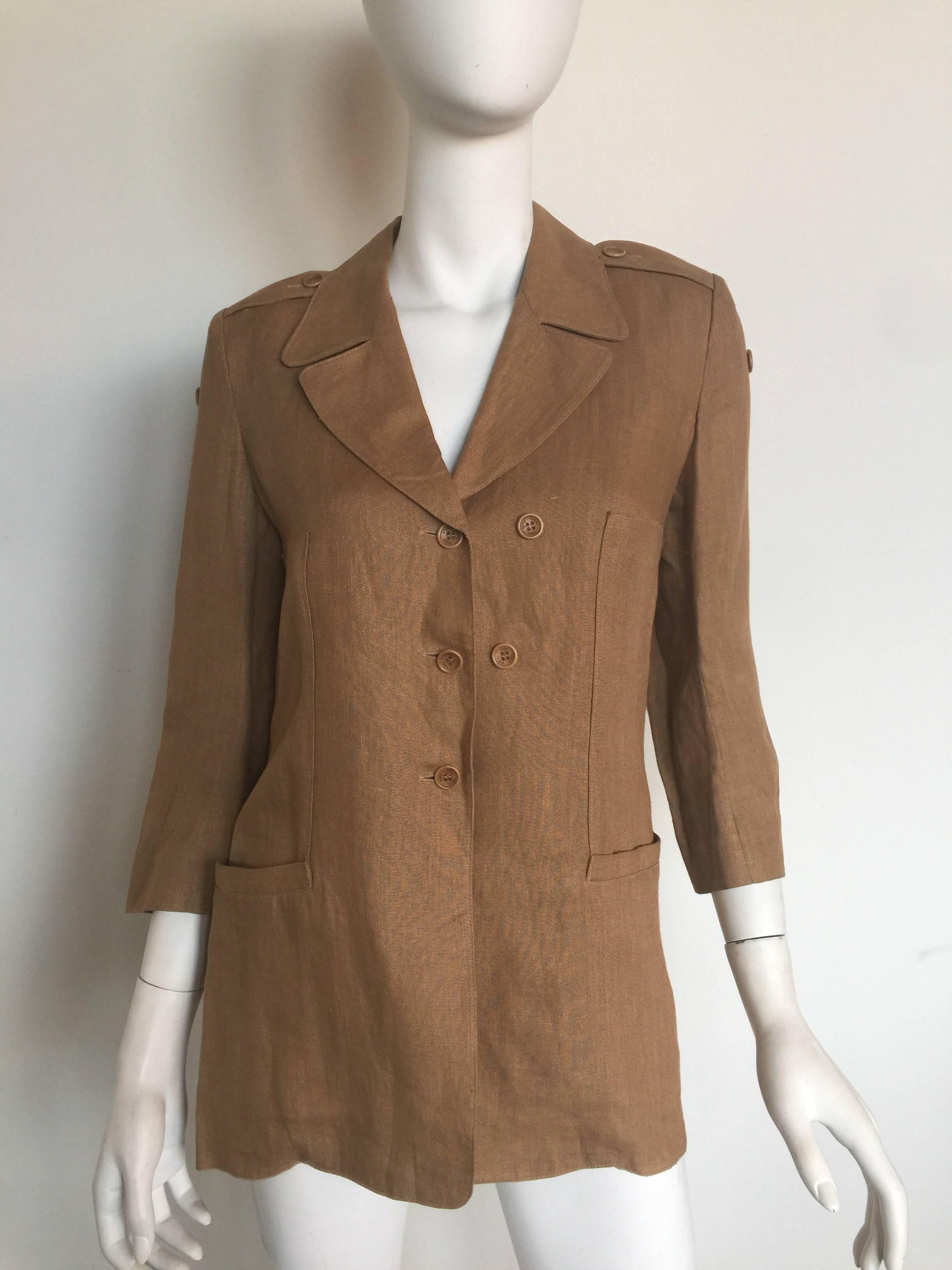 This camel linen blazer is Sonia Rykiel from the 1980s.  It is in great condition with two front pockets and original stamped buttons.  It is listed as a size 38 but please check measurements. 