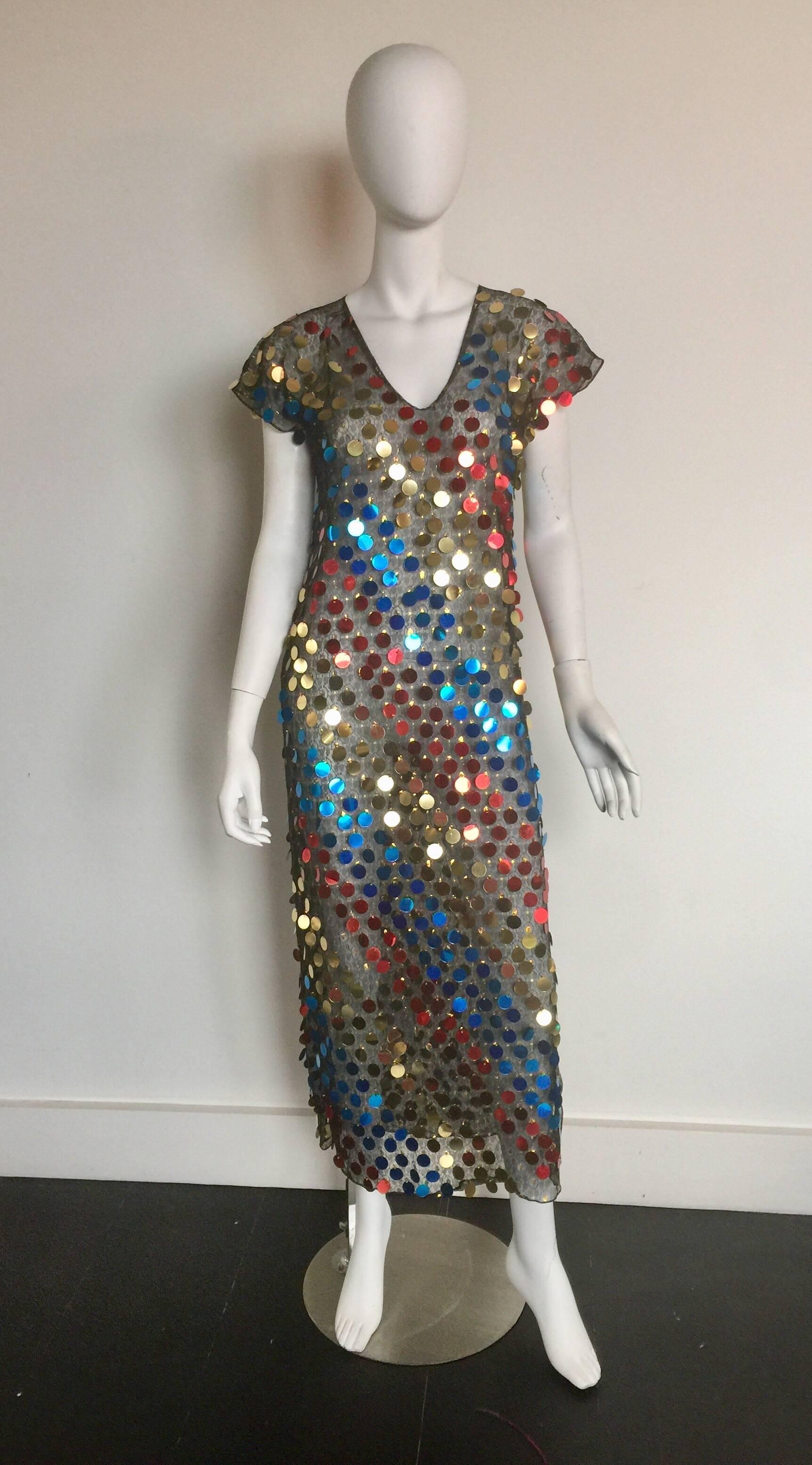 This sheer midi dress is covered in gold blue and red large sequins.  It is an awesome party dress or costume party piece.  It has a V neck and short sleeves.  It is in good condition and is not labeled a designer.  