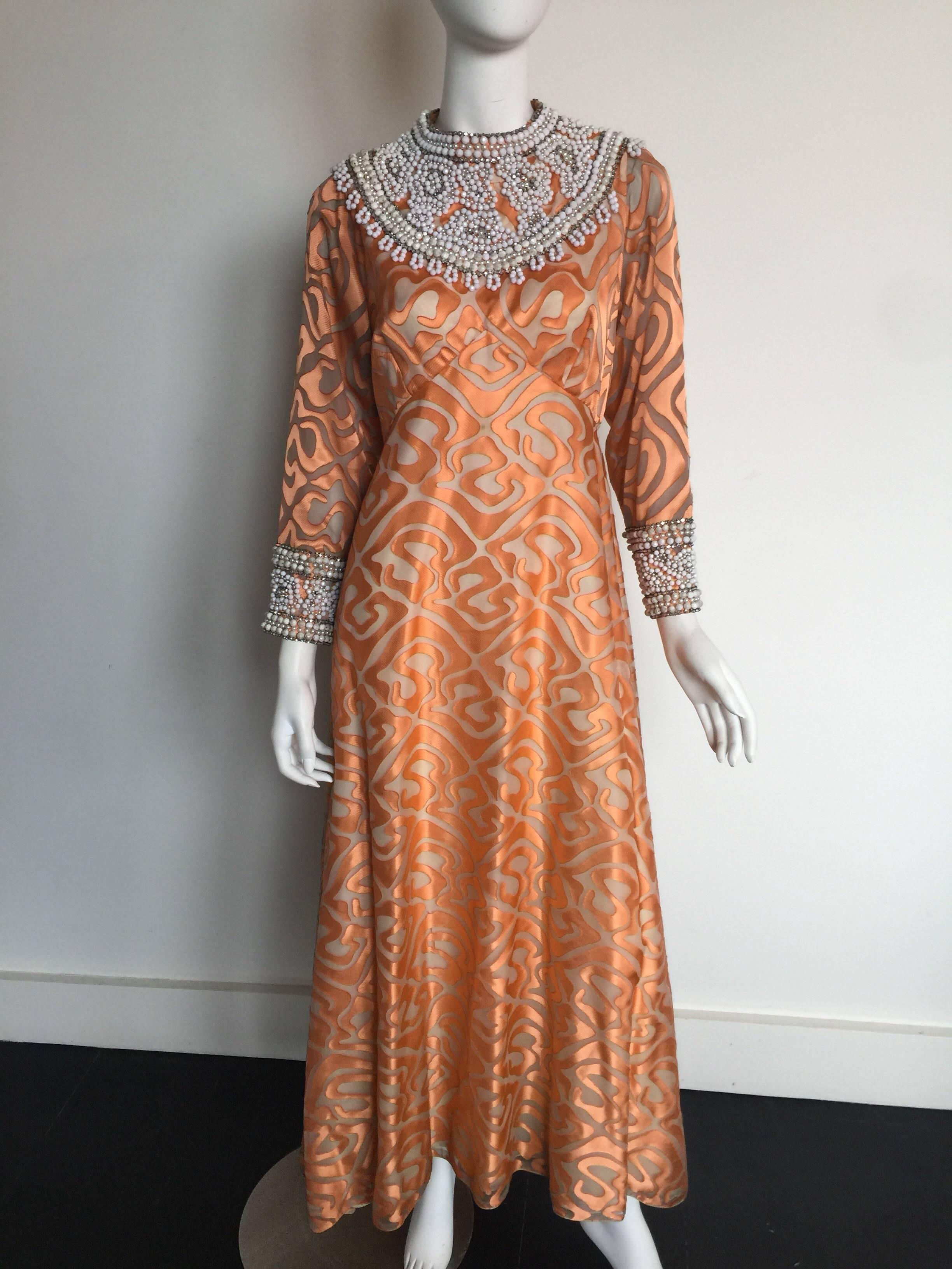 This 1970s coral beaded dress is from a New York Ateliers private collection.  The beading is in very good condition but there is some damaged as pictures to the coral silk and priced accordingly.  I have extra fabric which can be used for