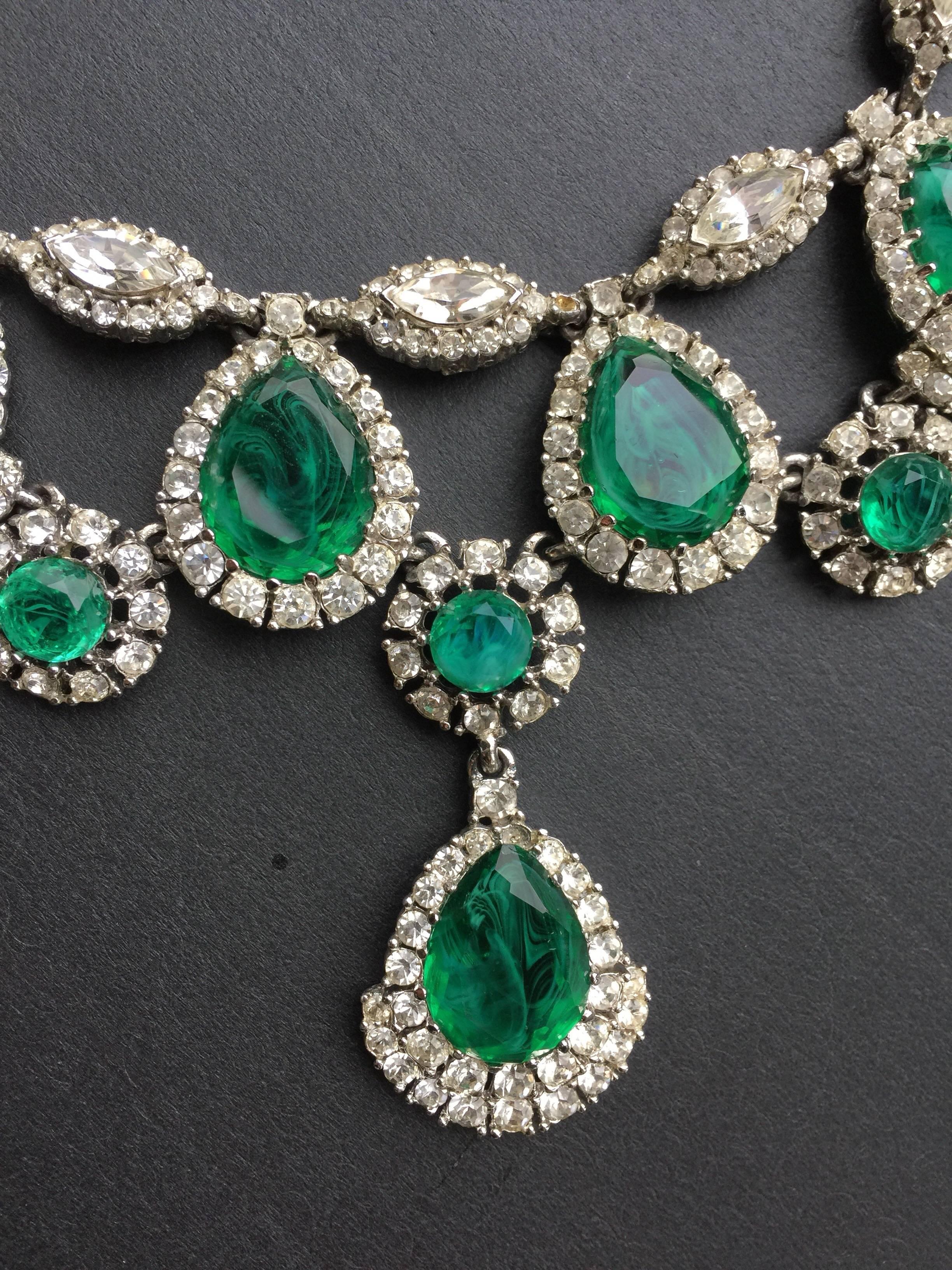 This a stunning emerald looking necklace.  This diner costume piece is from 1970s or 80s.  It has beautiful crystals and is in excellent condition. The center stone drops down 3" and the smaller stones drop 3/4th inch.