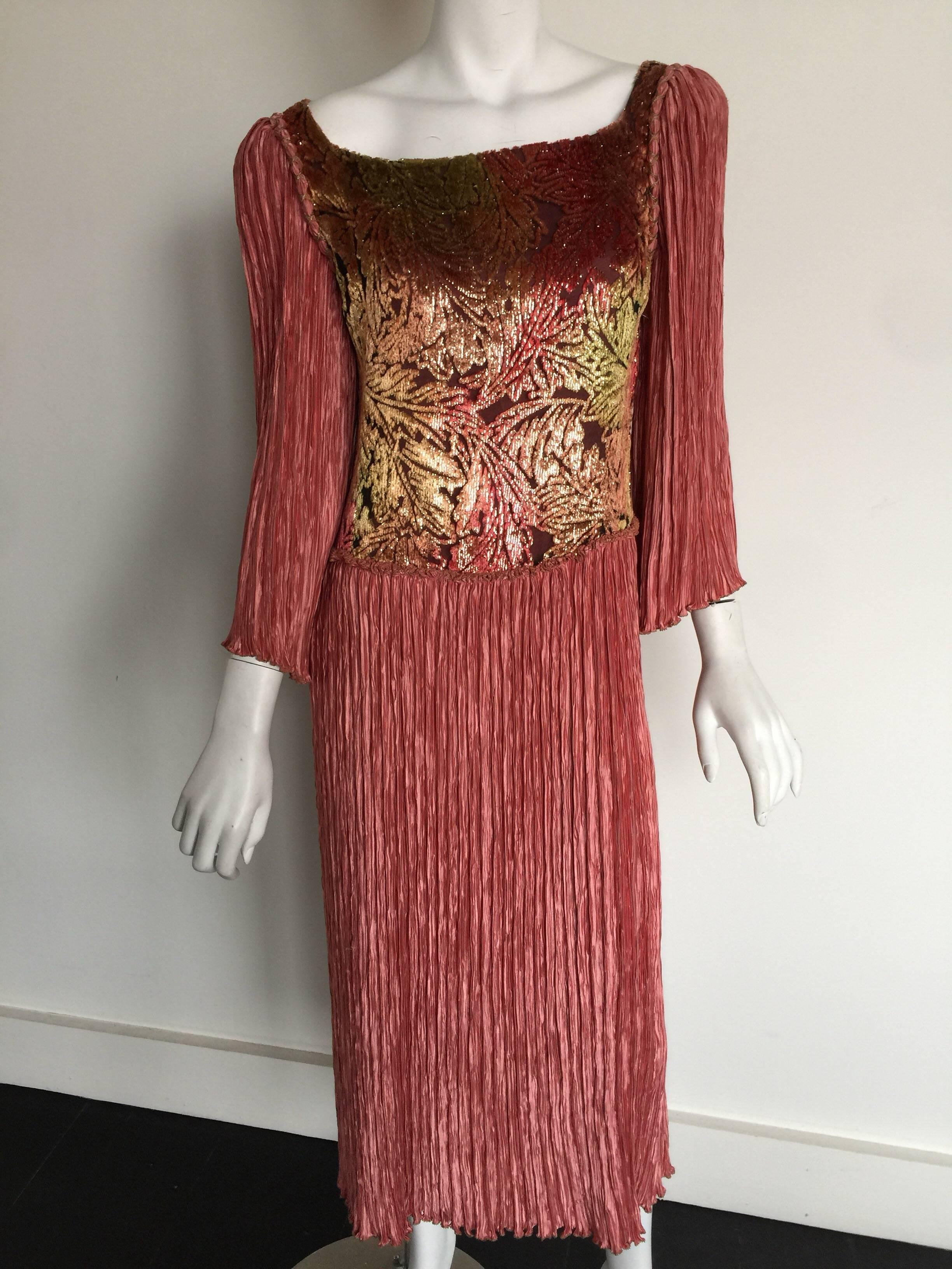 This Mary McFadden dress is a dusty pink silk with a metallic velvet bib front.  The velvet print looks like gold red autumn leaves.  Mary McFadden's micro pleated fabric is a tribute to Mario Fortuny.  The dress has the original Saks Fifth Avenue