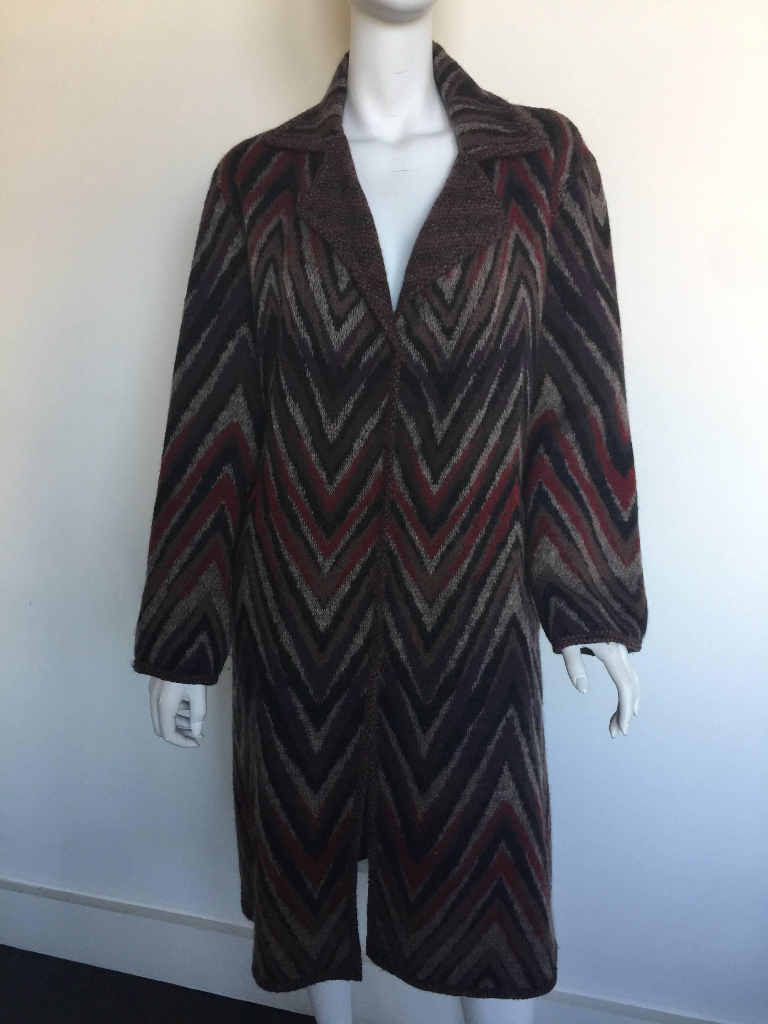 This reversible knit Missoni coat is shades of Burgundy and brown.  It has two pockets on both the outside and inside of the coat.  It is missing its tags but would fit most sizes 