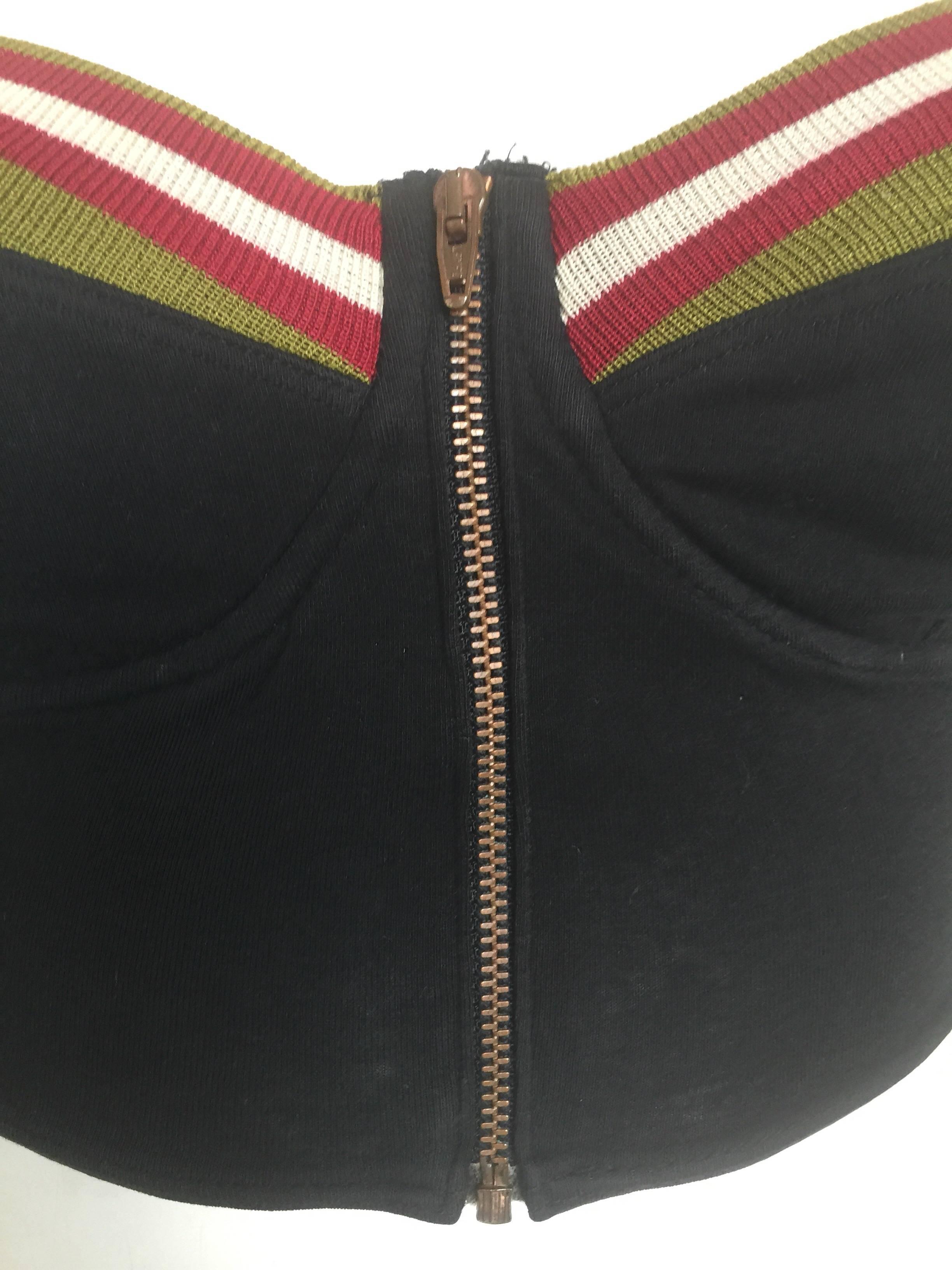 This 1980s Jean Paul Gaultier Junior crop top is listed a 44 but has been altered to fit more like a size 38.  Please check measurements.  It has a from zipper opening and elastic criss cross straps. 