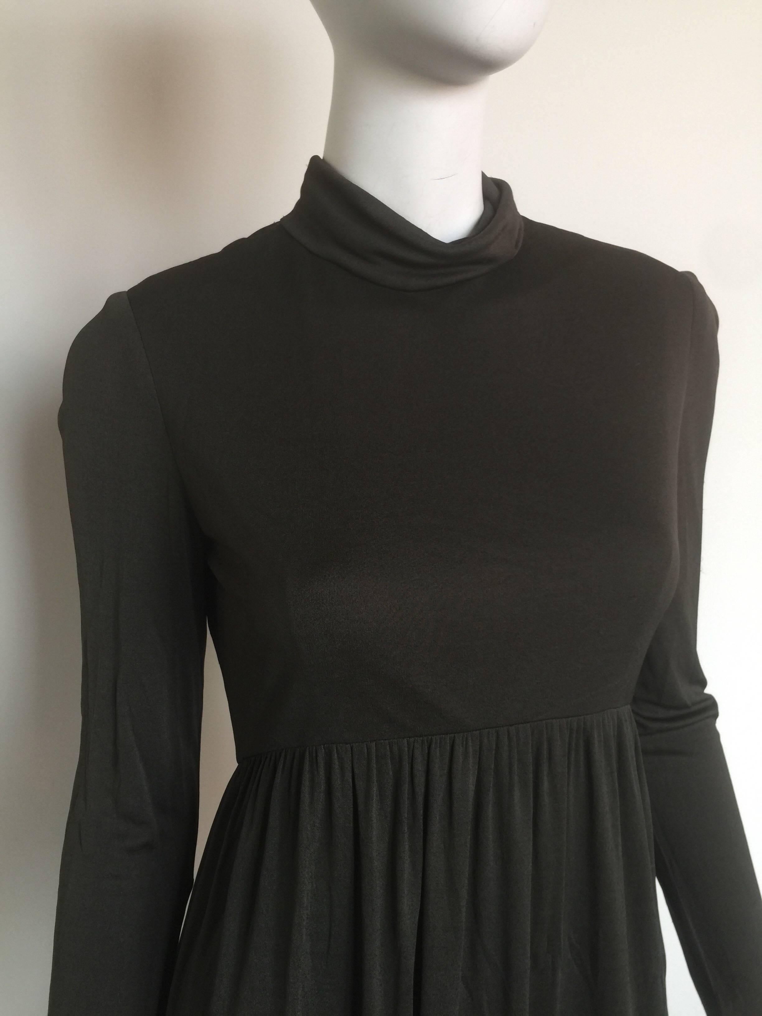This is a 1970s Rodrigues silk jersey turtleneck dress.  It has long sleeves and a bag zipper.  It is a great army green color. 