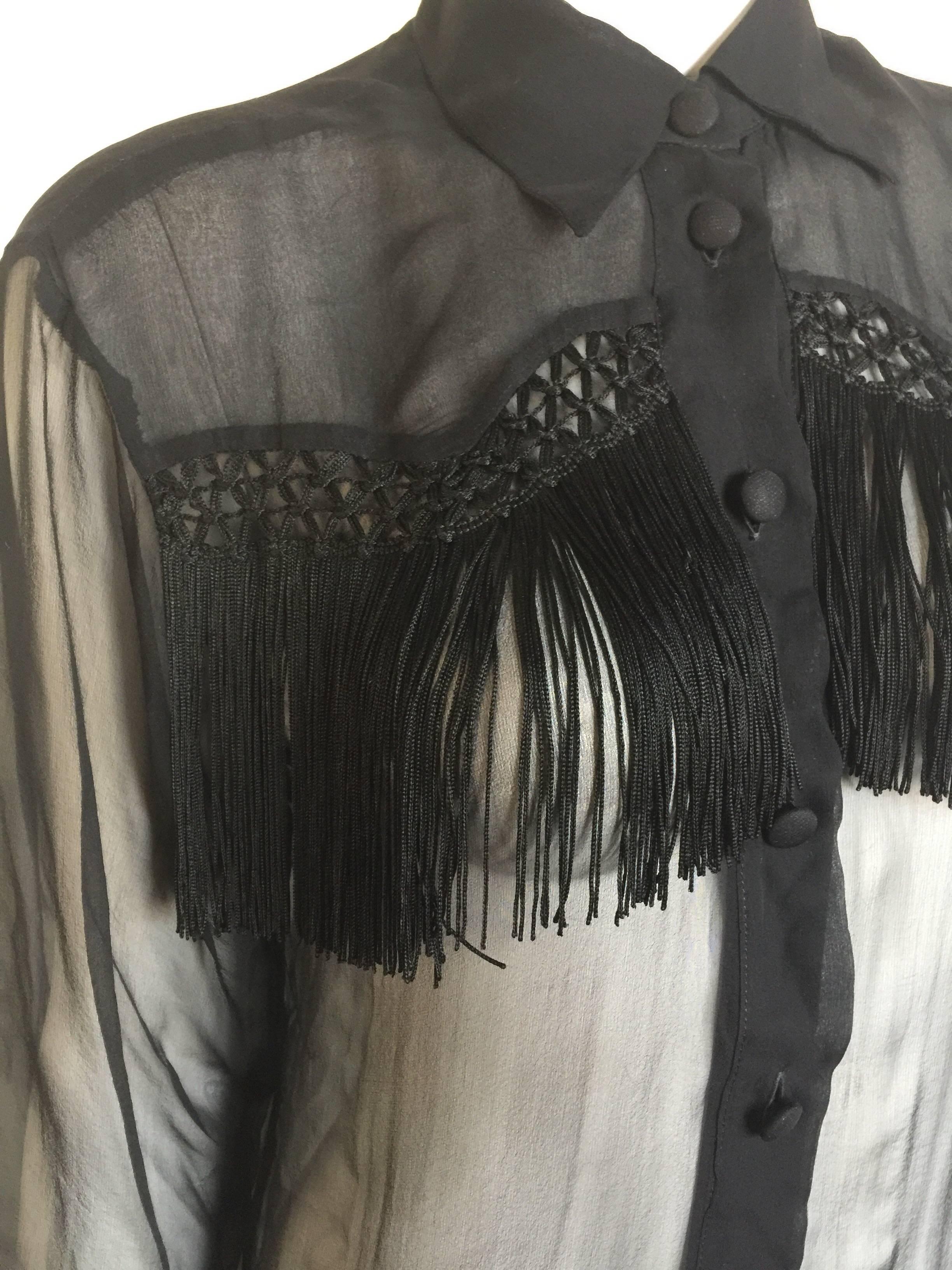 This 1980s Moschino Couture blouse is a silk chiffon and very sheer with a cowboys ilk fringe.  