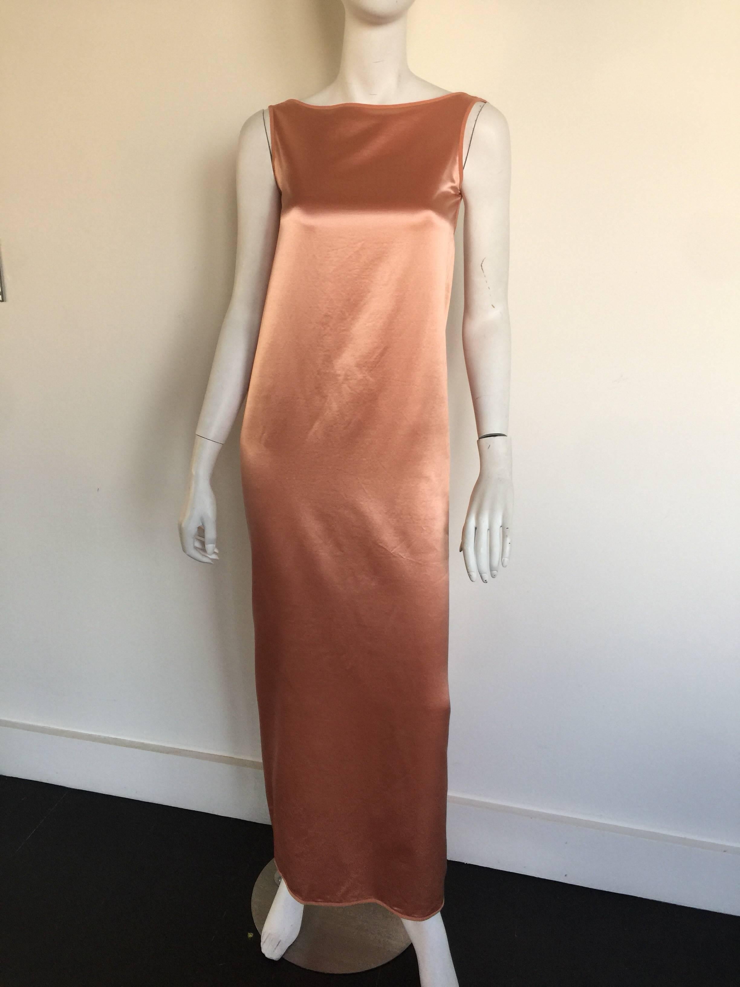 This Isaac Mizrahi blush slip dress has a high boat neck and a cowl low back.  It fits a 0-2.  It is a beautiful color and a great take on the 1990s slip dress. 