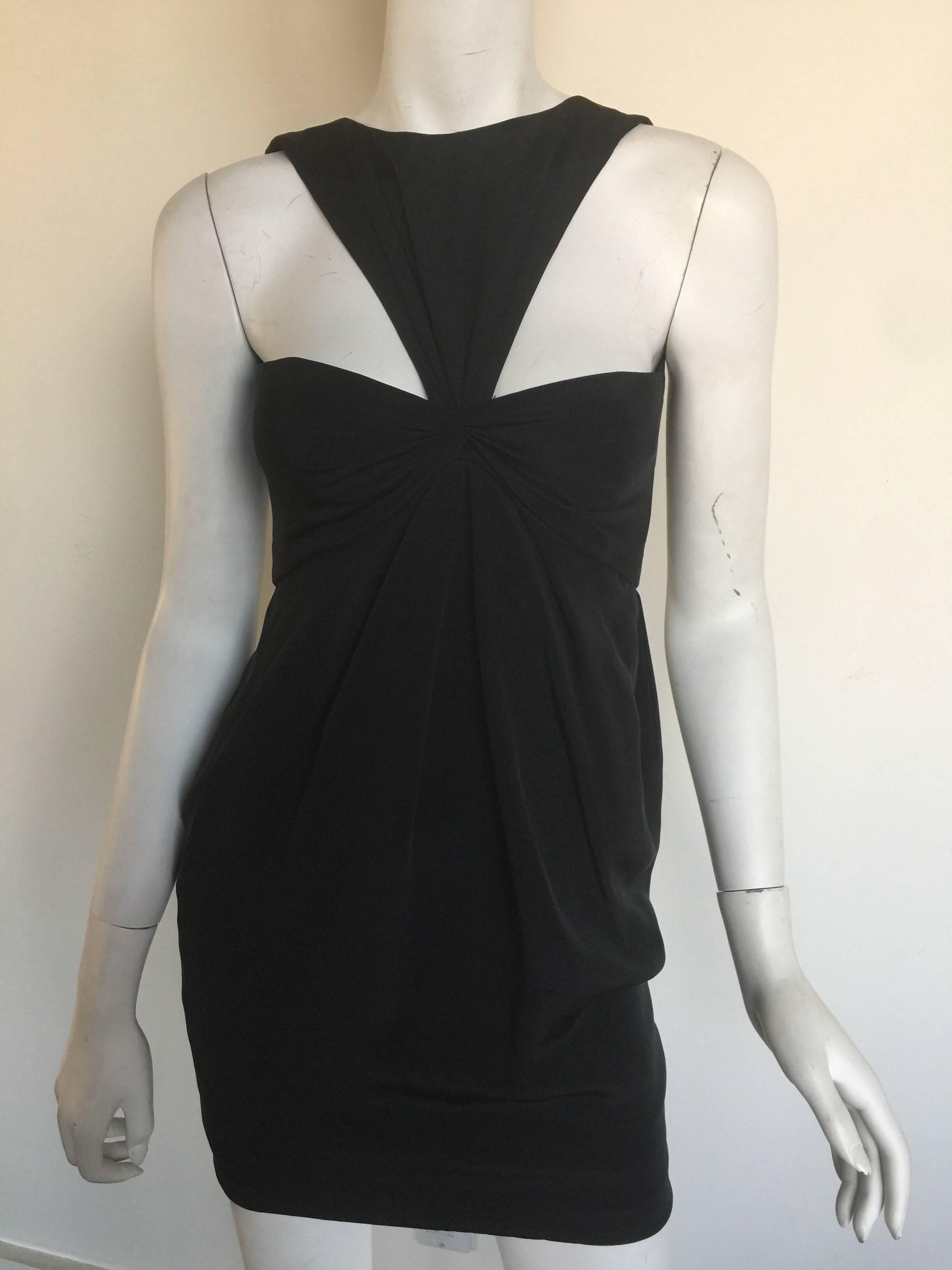 This iconic Bill Blass mini dress is from the 1980s.   It is a silk crepe and fits a 0-2.  There is about 2 inches in hemline that can be let out.