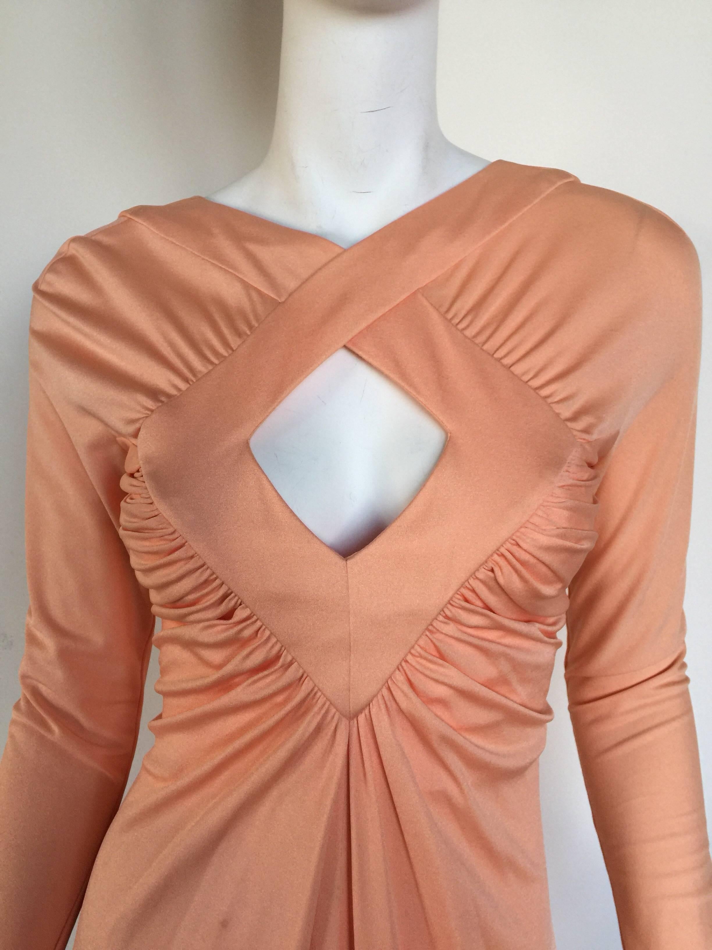 This peach silk jersey dress has a gorgeous draped keyhole bust line and a fairly open body so fits many sizes.  I believe it is Estevez but it has lost its label. 