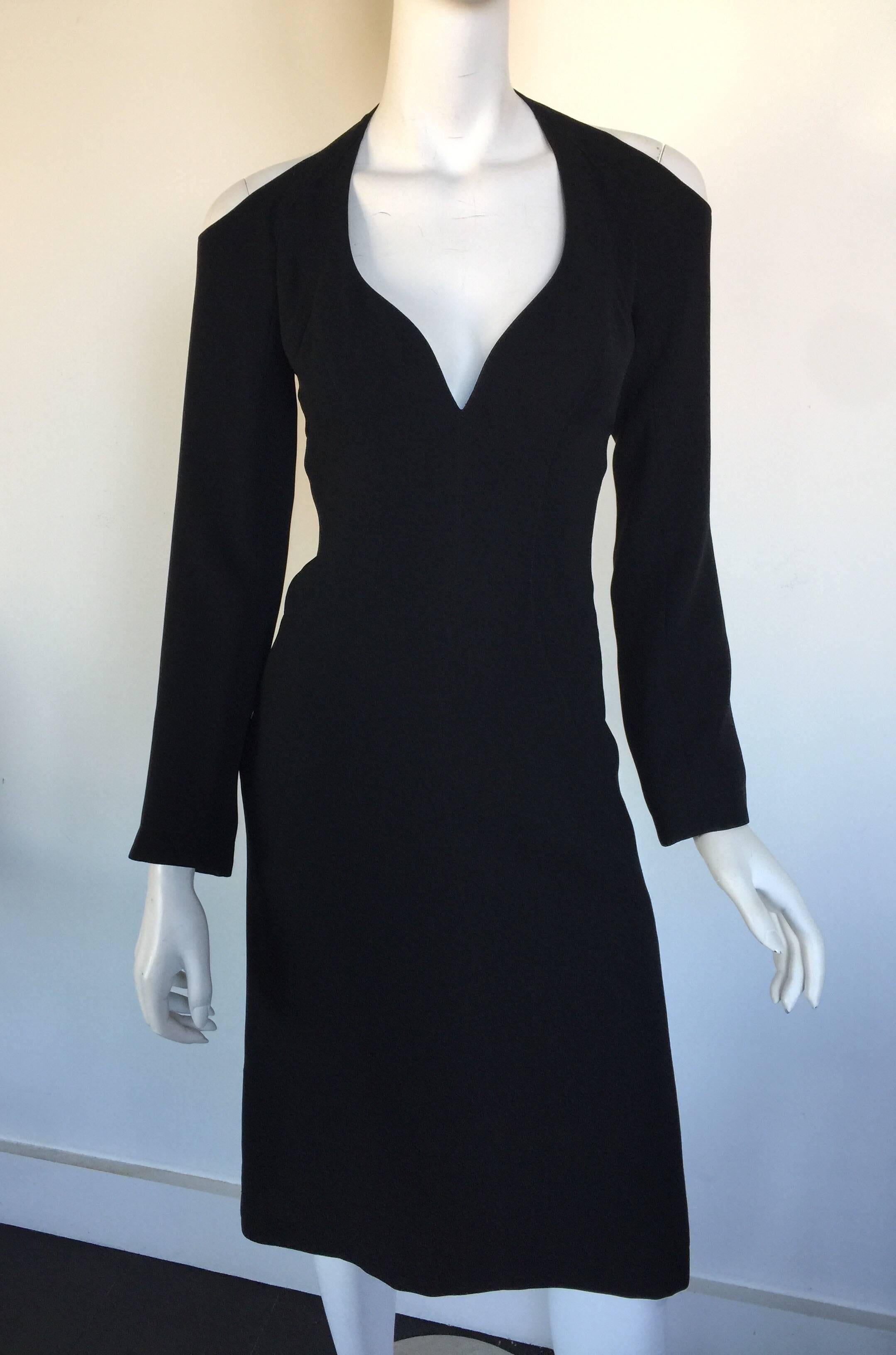 This 1980s Thierry Mugler dress has a tiny waist and larger bust.  It can be altered but please check measurements.  The shoulder has a cut out detail and slightly bell sleeves.  It is labelled a size 36 