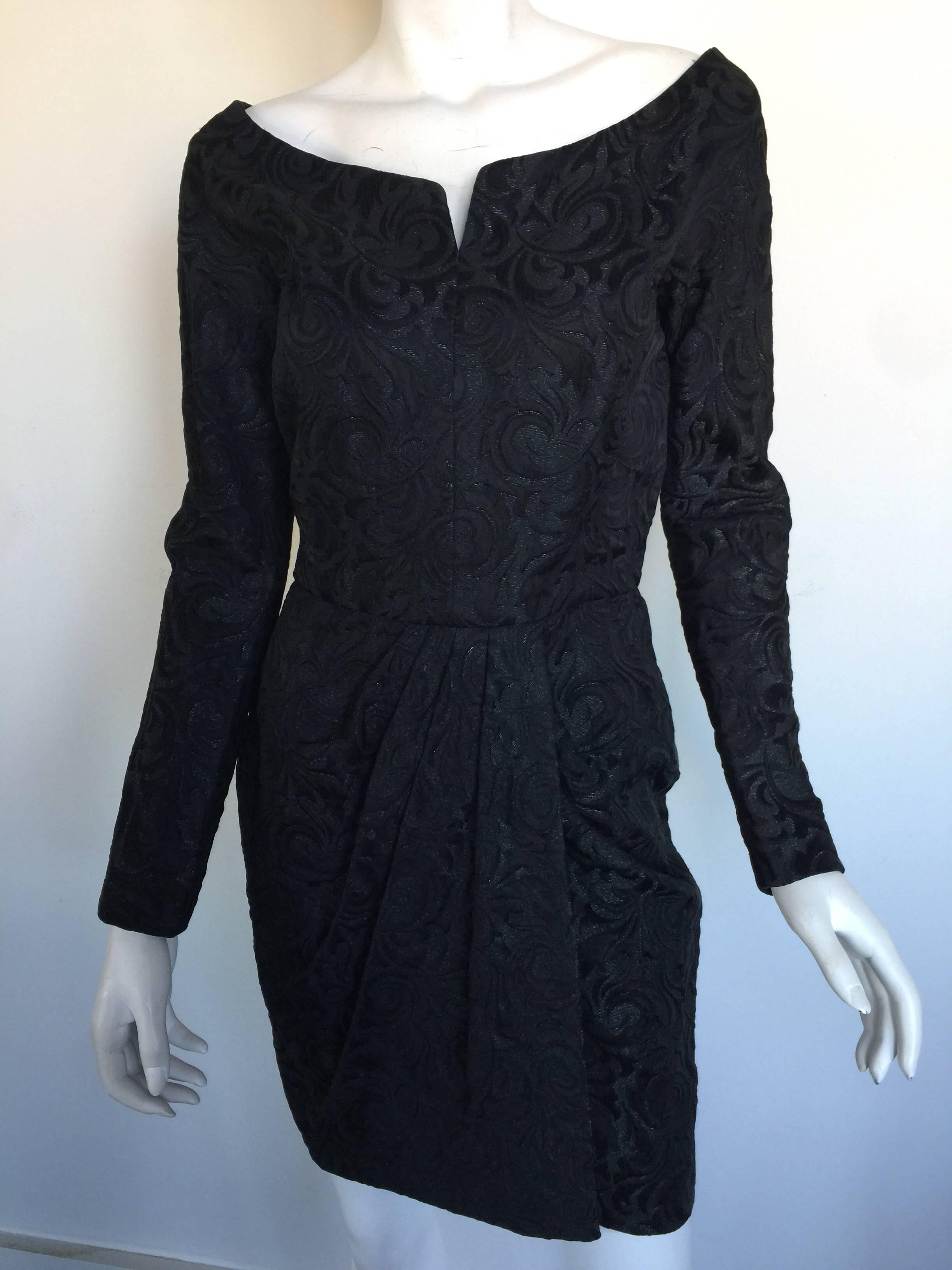 This 1980s Anne Klein dress is a black brocade mini dress.  Perfect for the holidays.  Boat neck and synched waistline with a draped skirt. 