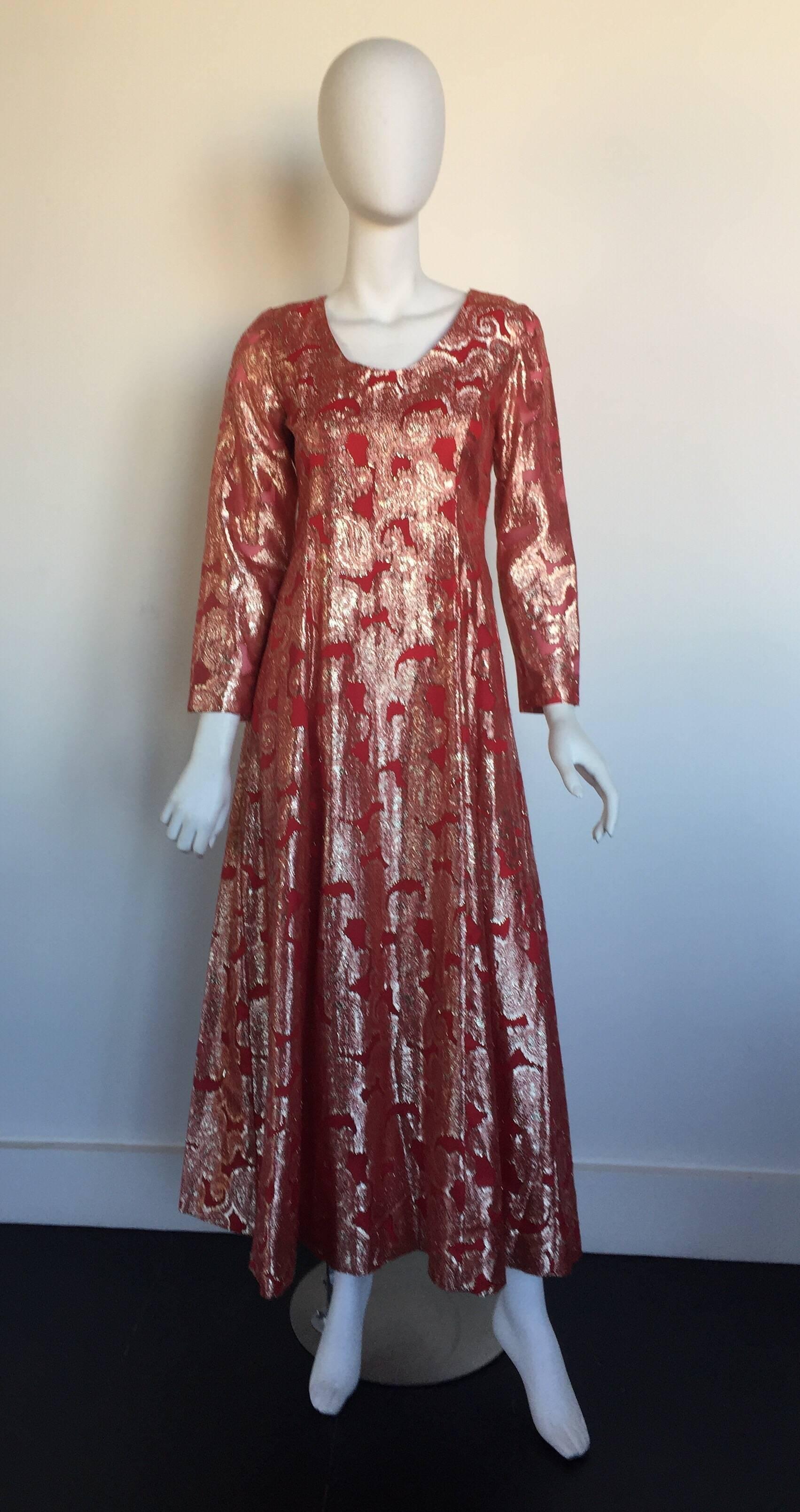 This cool 1970s long sleeve maze dress has a burnt orange/red and gold brocade design.  