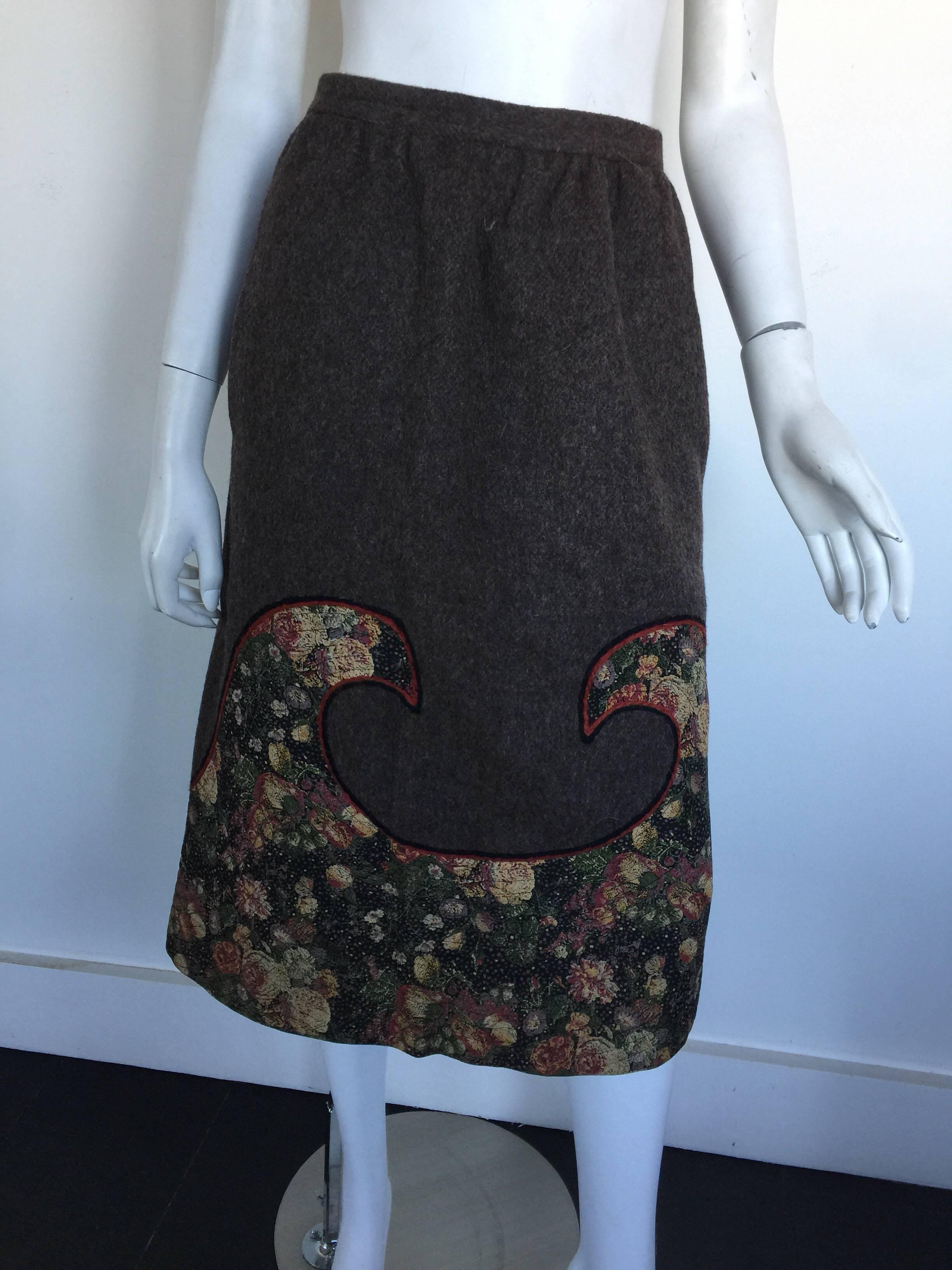 This Koos brown skirt is 100% wool with a winning.  it has a wave like patchwork design at the bottom and is labelled a size 6 but please check measurements. 
