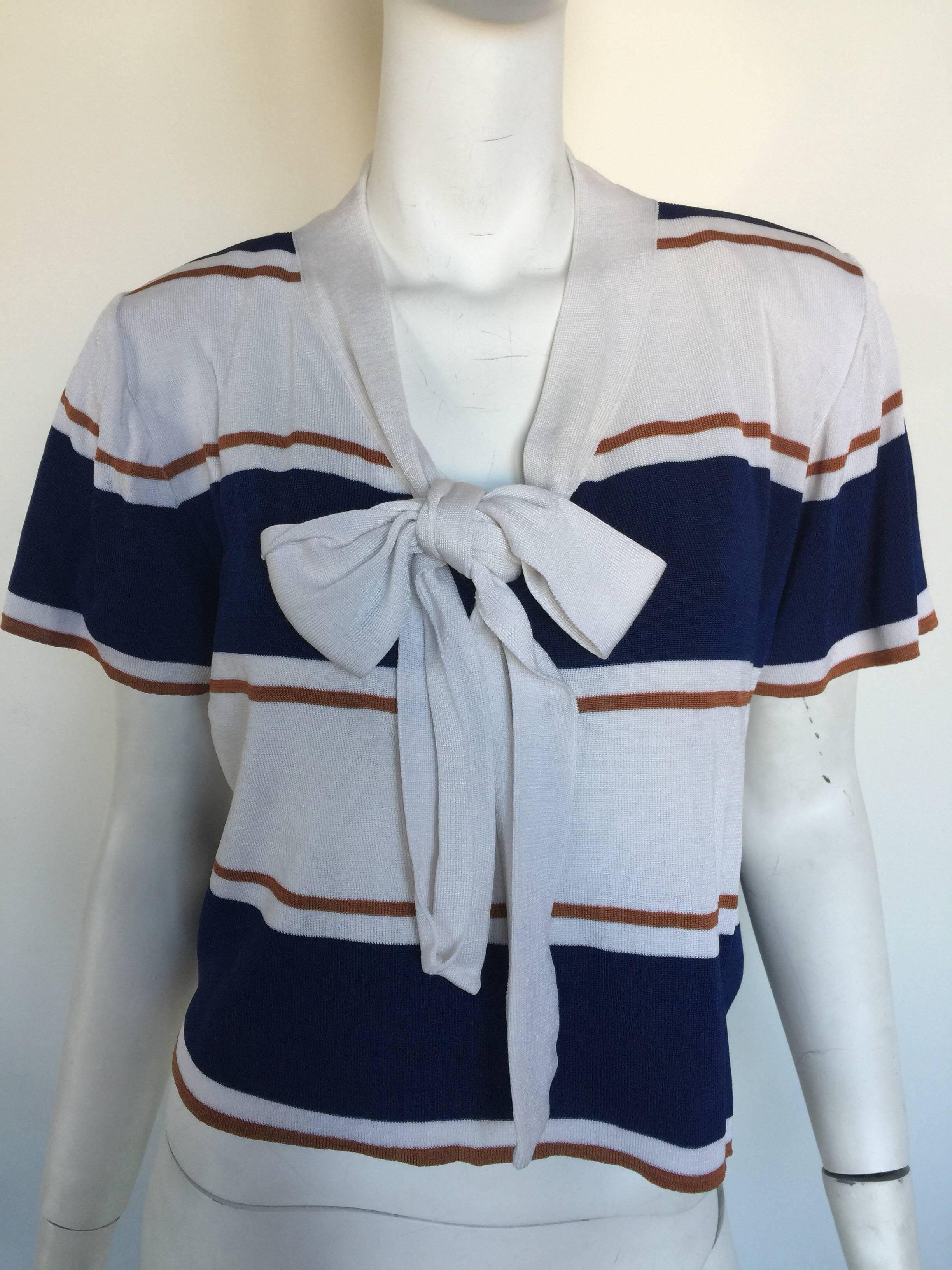 This lightweight Givenchy knit has navy and Carmel color stripes.  It is slightly cropped with a bow tie in the front.  