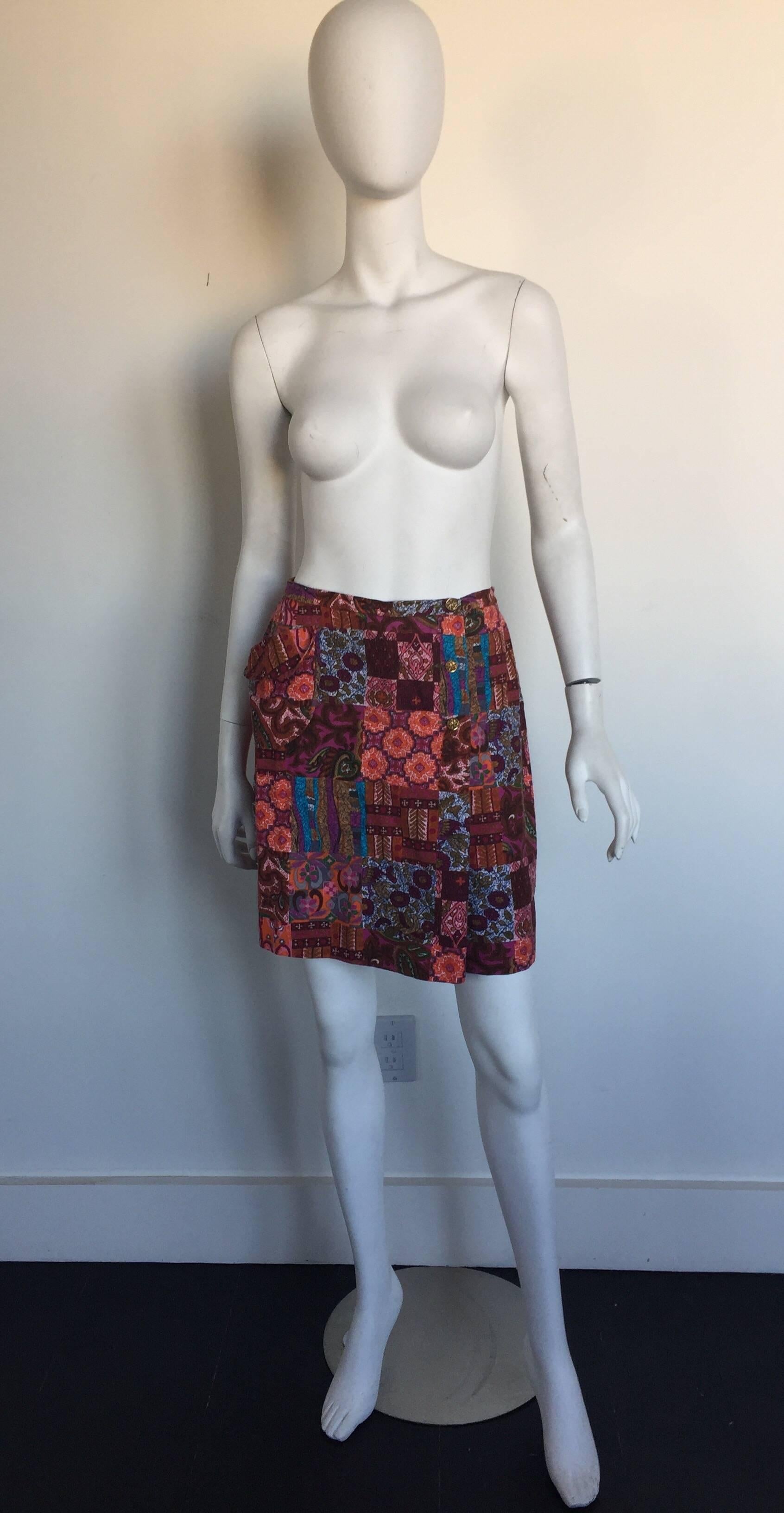 This 1970s cotton printed skort looks like a skirt but is really shorts.  It has a single side pocket and gold buttons down the left leg.  It is a cute summer or fall look!