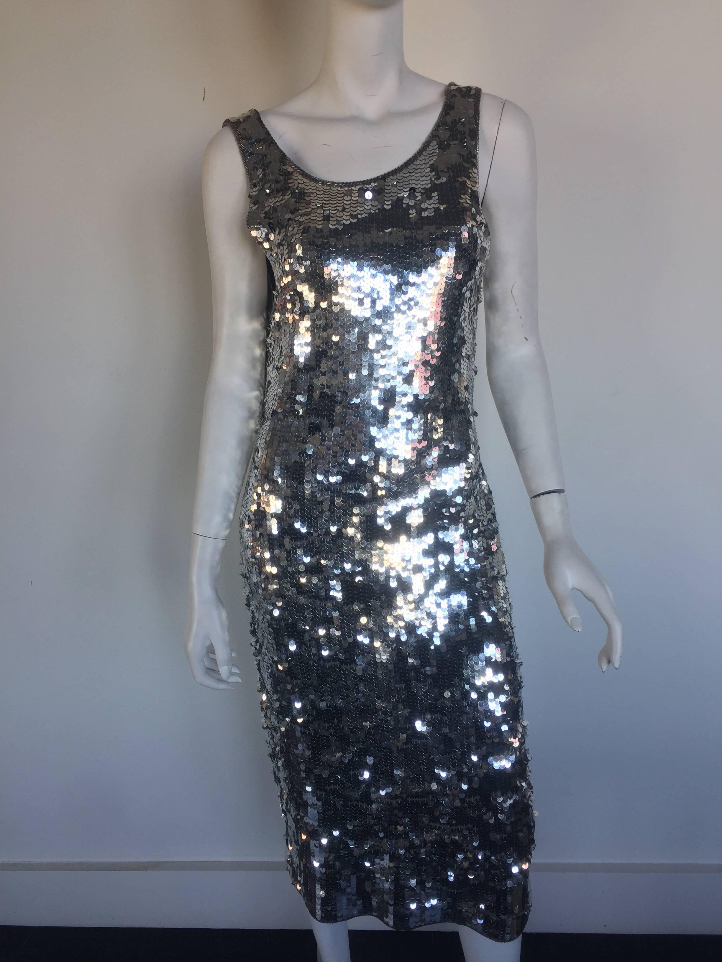 This is the perfect New Years eve dress.  The midi length fully sequin silver dress is lambswool pinned and backless for extra dramatic effect.  It is a M but fits a range of sizes.  Labelled Cathy Hardwick 